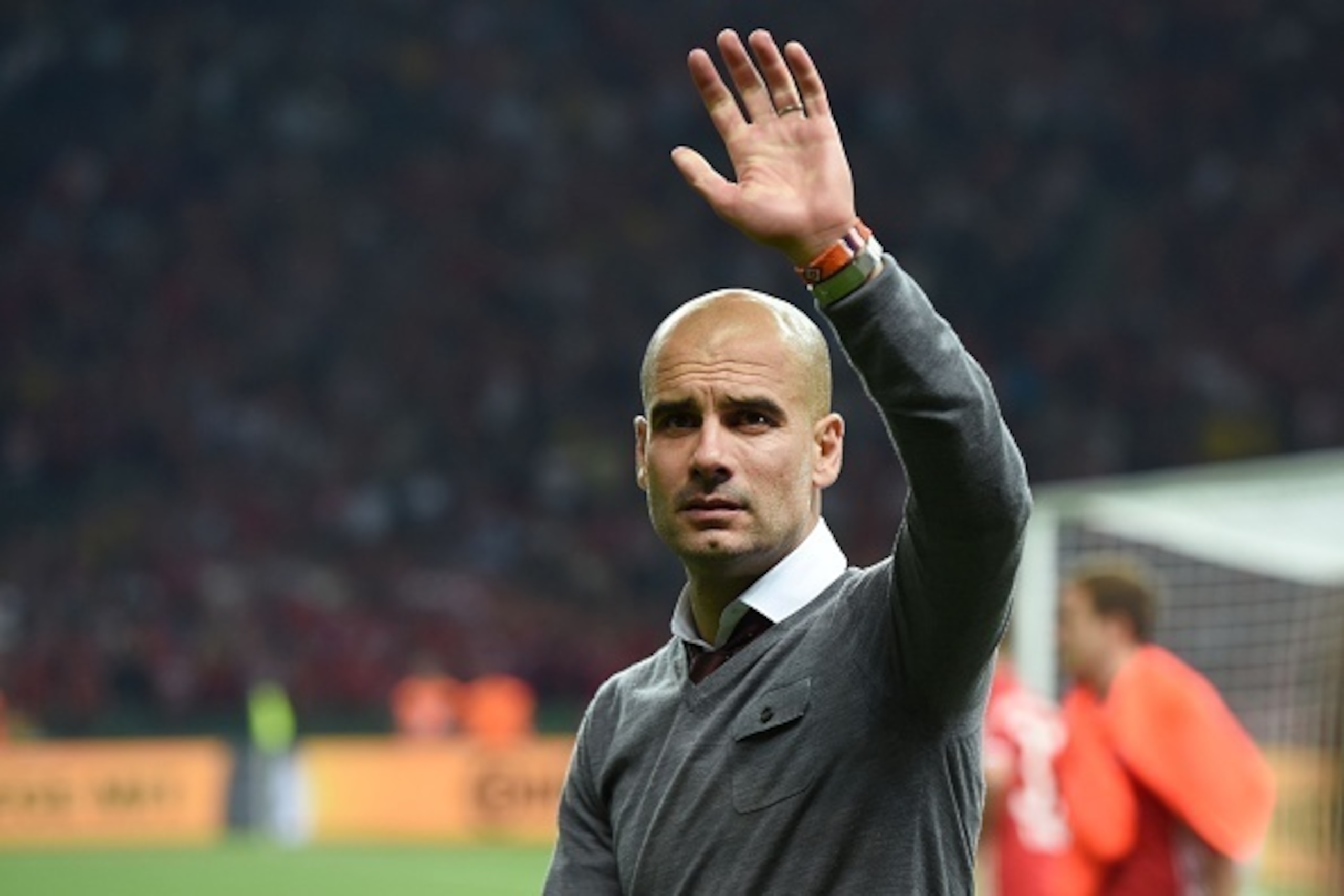 Bayern Munich's Spanish head coach Pep Guardiola waves to the fans after Bayern Munich defeated Dortmund in the penalty shootout during the German Cup (DFB Pokal) final football match Bayern Munich vs Borussia Dortmund at the Olympic stadium in Berlin on 