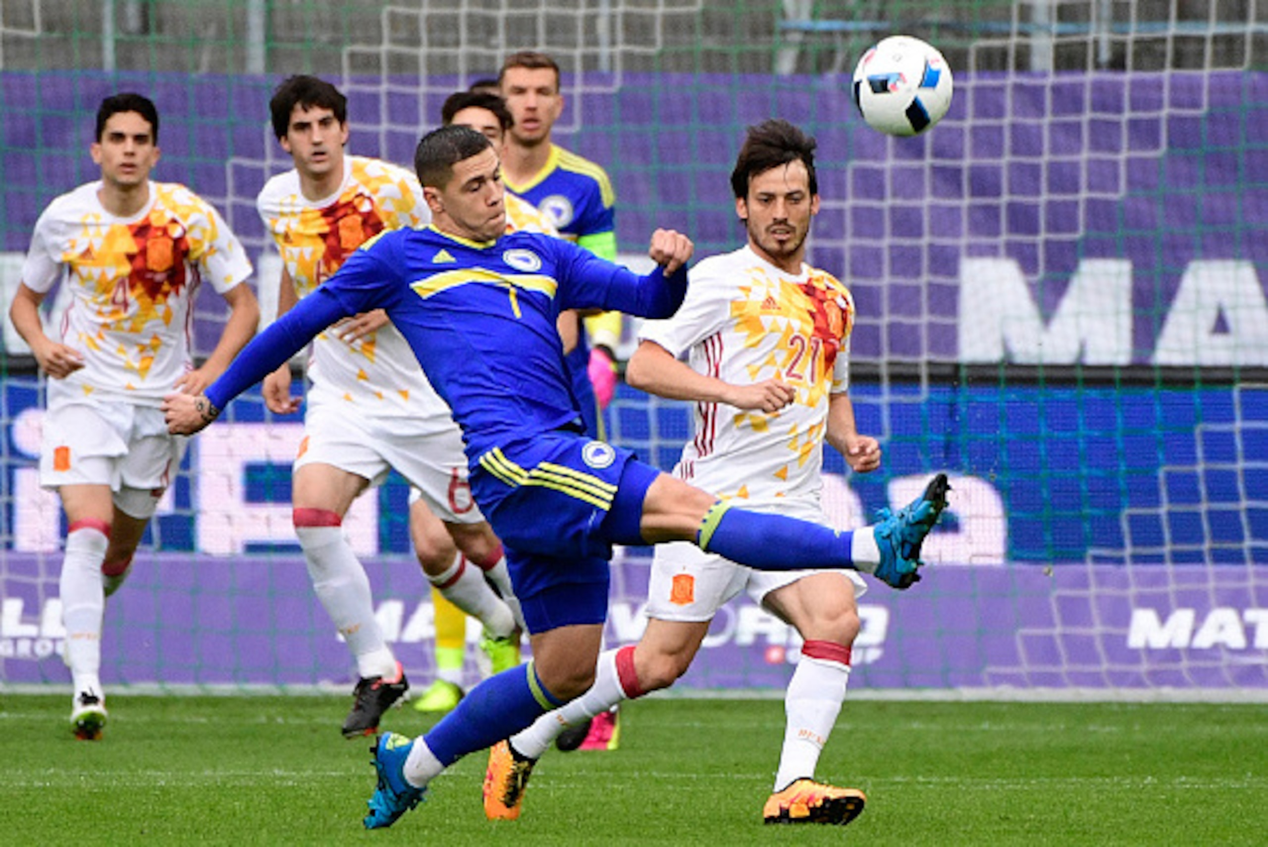 Spain's forward David Silva (R) vies with Bosnia's forward Muhamed Besic during the friendly football match Spain versus Bosnia at the AFG Arena in St. Gallen on May 29, 2016 in preparation for the upcoming Euro 2016 European football championships. / AFP
