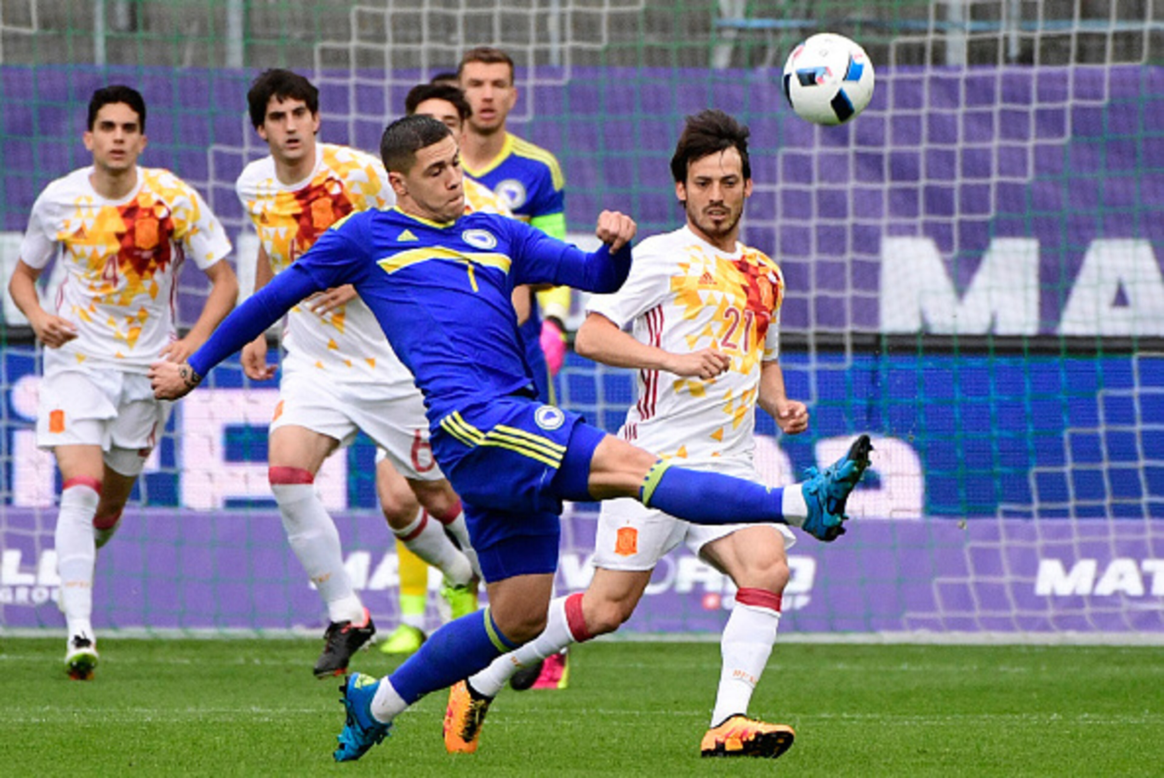 Spain's forward David Silva (R) vies with Bosnia's forward Muhamed Besic during the friendly football match Spain versus Bosnia at the AFG Arena in St. Gallen on May 29, 2016 in preparation for the upcoming Euro 2016 European football championships. / AFP