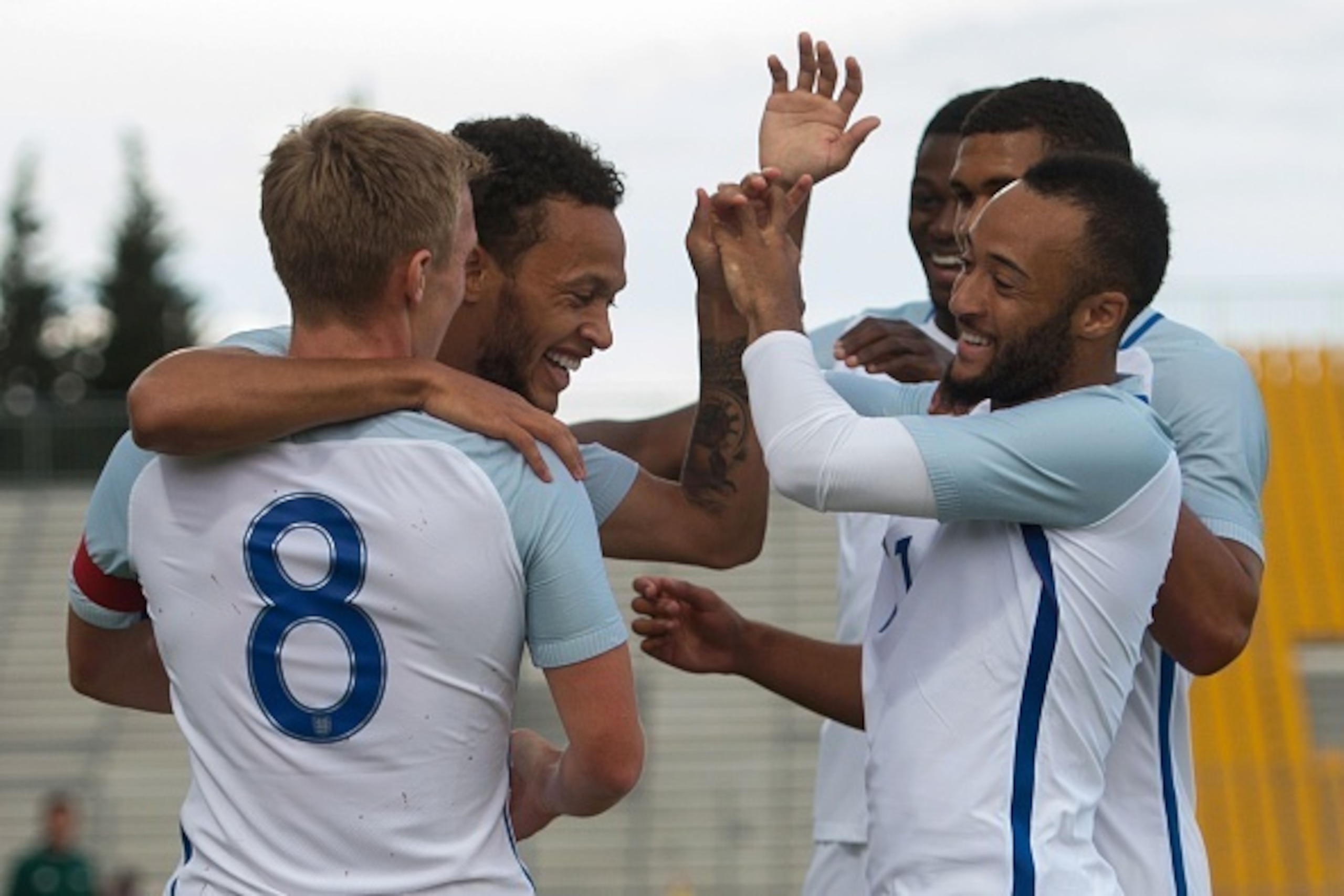 England's forward Lewis Baker celebrates with teammates after scoring during the Festival International Espoirs Under 21 football match final France vs England at the Parc des Sports stadium in Avignon, southern France, on May 29, 2016.  / AFP / BERTRAND 