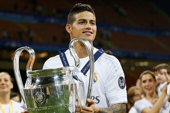 MILAN, ITALY - MAY 28:  James Rodriguez of Real Madrid celebrates victory with the trophy after winning the Champions League final match between Real Madrid and Club Atletico de Madrid at Stadio Giuseppe Meazza on May 28, 2016 in Milan, Italy.  (Photo by 