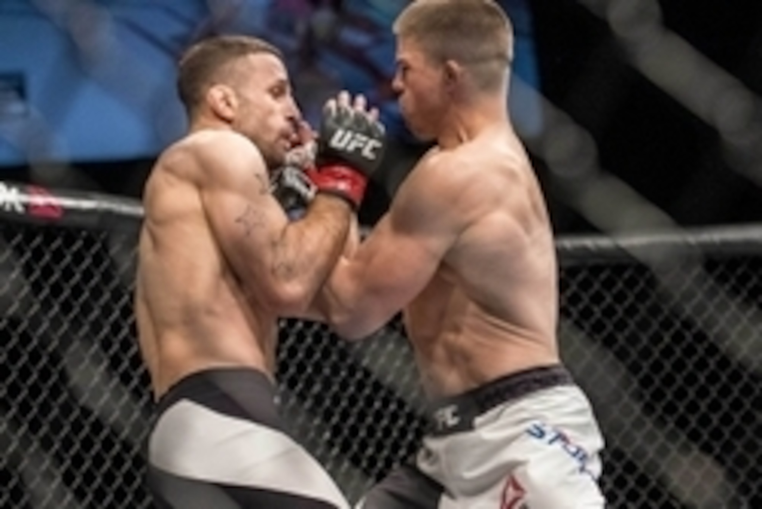 May 29, 2016; Las Vegas, NV, USA; Rick Story (blue gloves) and Tarec Saffiedine (red gloves) compete during UFC Fight Night at Mandalay Bay Events Center. Mandatory Credit: Joshua Dahl-USA TODAY Sports