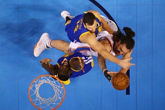 OKLAHOMA CITY, OK - MAY 24:  Steven Adams #12 of the Oklahoma City Thunder goes up against Andrew Bogut #12 and Draymond Green #23 of the Golden State Warriors in the first quater in game four of the Western Conference Finals during the 2016 NBA Playoffs 