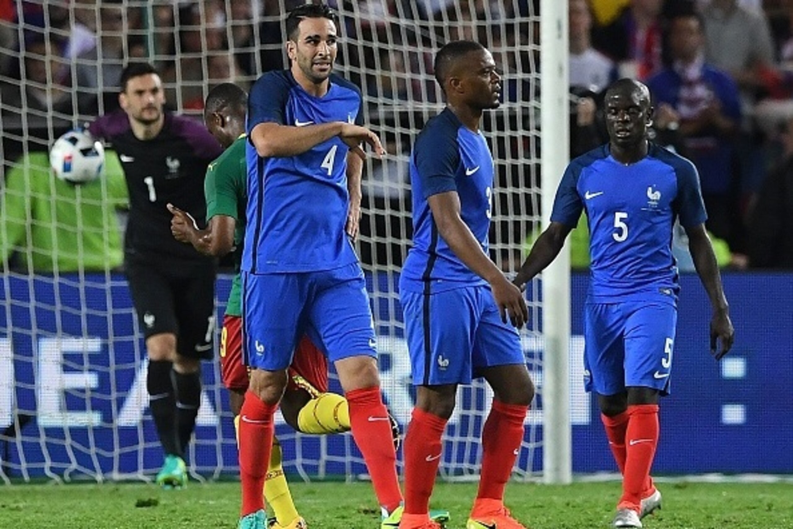 (From L) France's goalkeeper Hugo Lloris, France's defender Adil Rami, France's defender Patrice Evra and France's midfielder N'Golo Kante react after a goal scored by Cameroon  during the friendly football match between France and Cameroon, at the Beaujo