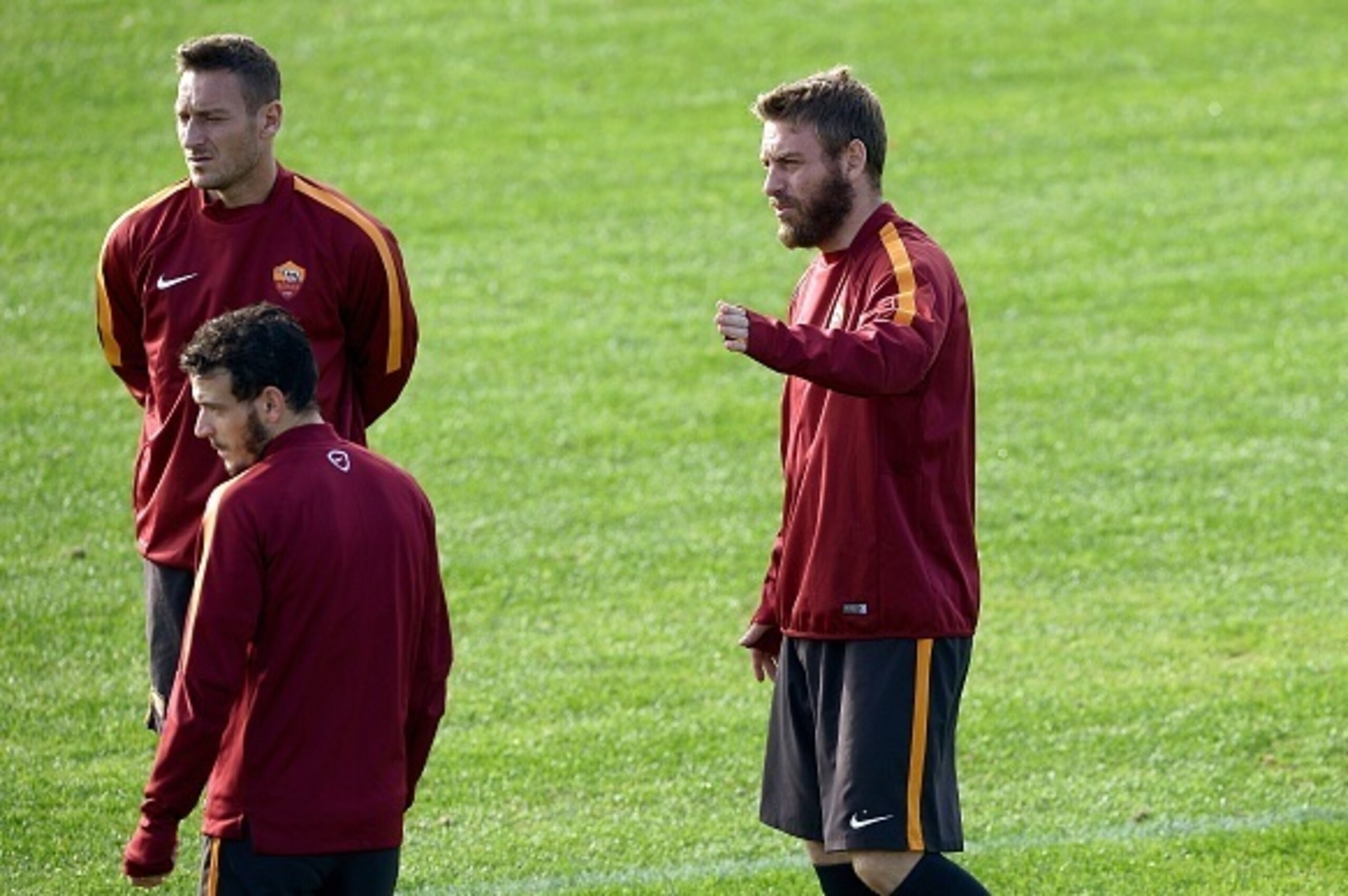AS Roma forward and captain Francesco Totti (L), midfielder Alessandro Florenzi and midfielder Daniele De Rossi (R) attend a training session on the eve of the UEFA Champions League football match AS Roma vs Manchester City on December 9, 2014 at the Trig