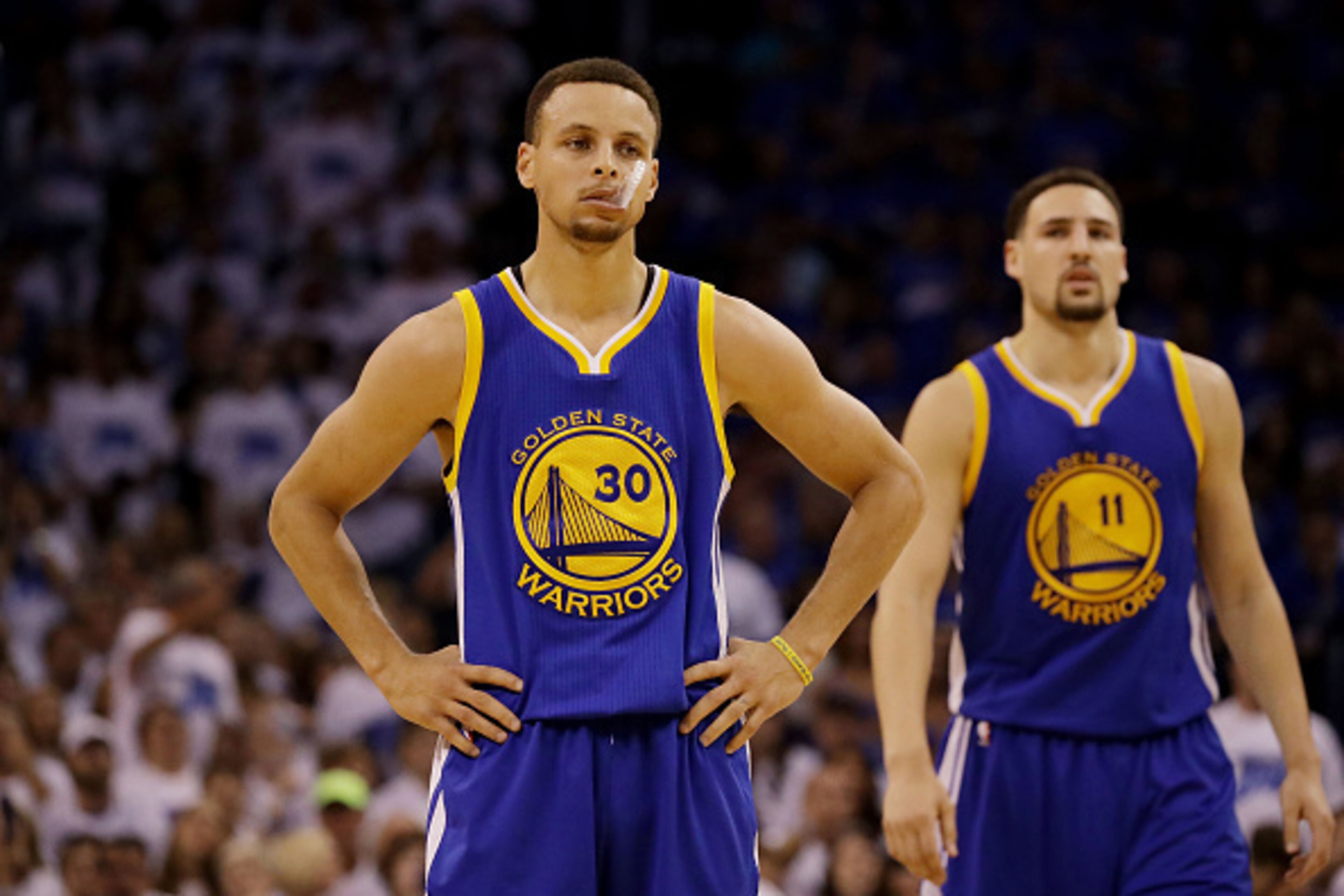 OKLAHOMA CITY, OK - MAY 22:  Stephen Curry #30 and Klay Thompson #11 of the Golden State Warriors react in the second quarter against the Oklahoma City Thunder in game three of the Western Conference Finals during the 2016 NBA Playoffs at Chesapeake Energ