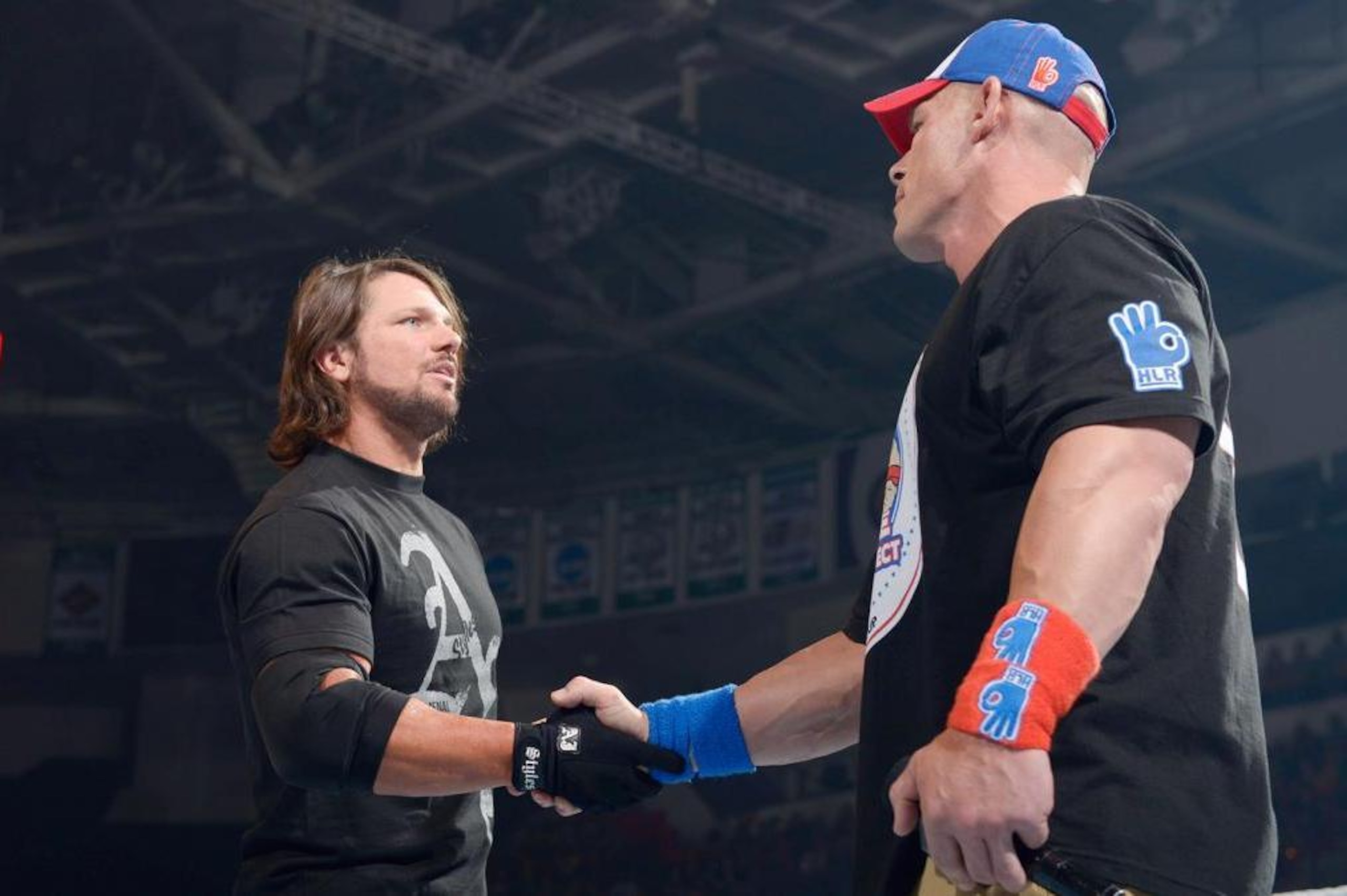 Styles shakes hands with Cena before the attack.