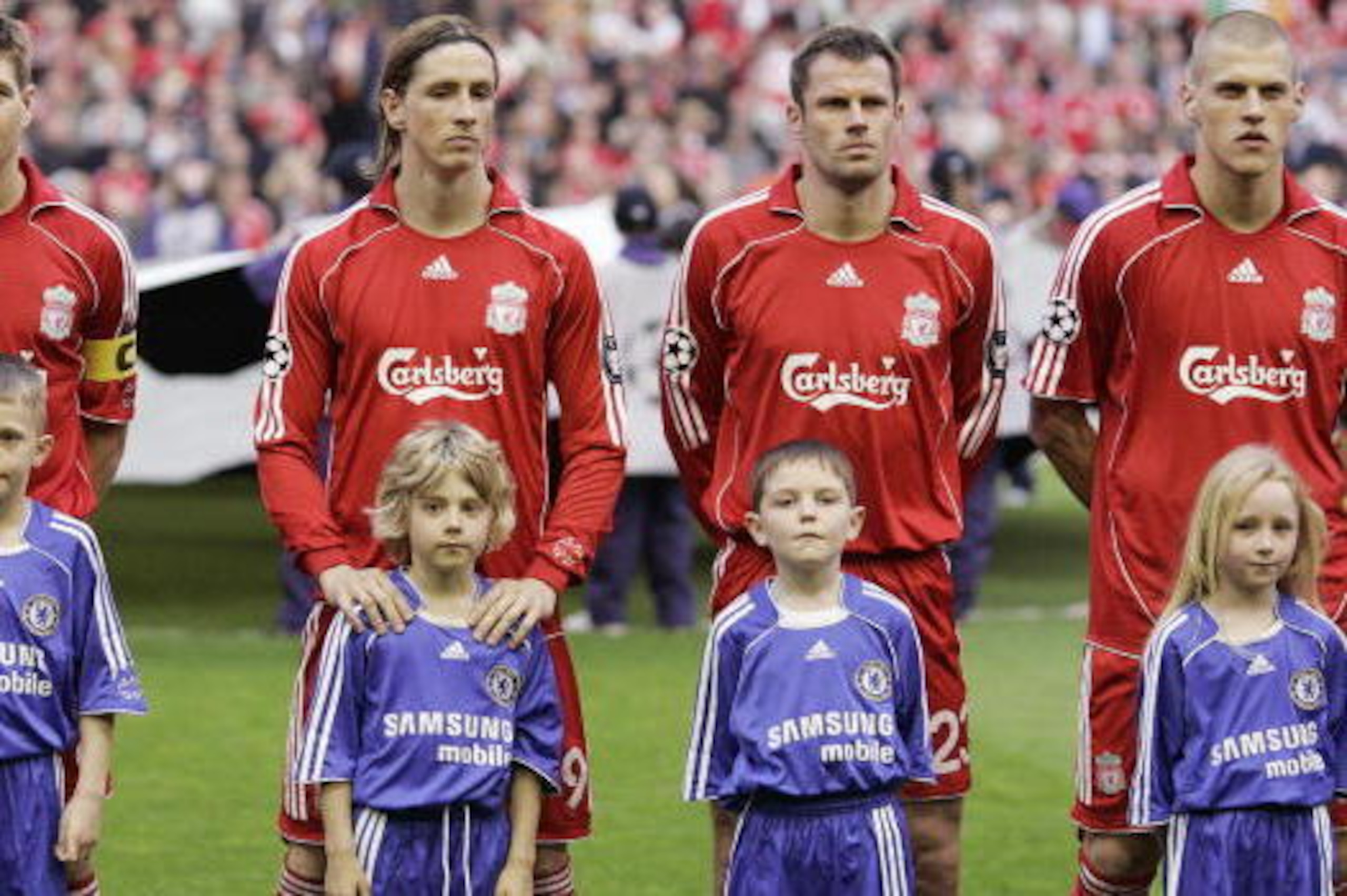 Liverpool footballers (L to R, Up) English midfielder Steven Gerrard, Spanish forward Fernando Torres, English defender Jamie Carragher and Slovakian defender Martin Skrtel line up with children before their UEFA Champions League semi-final football match