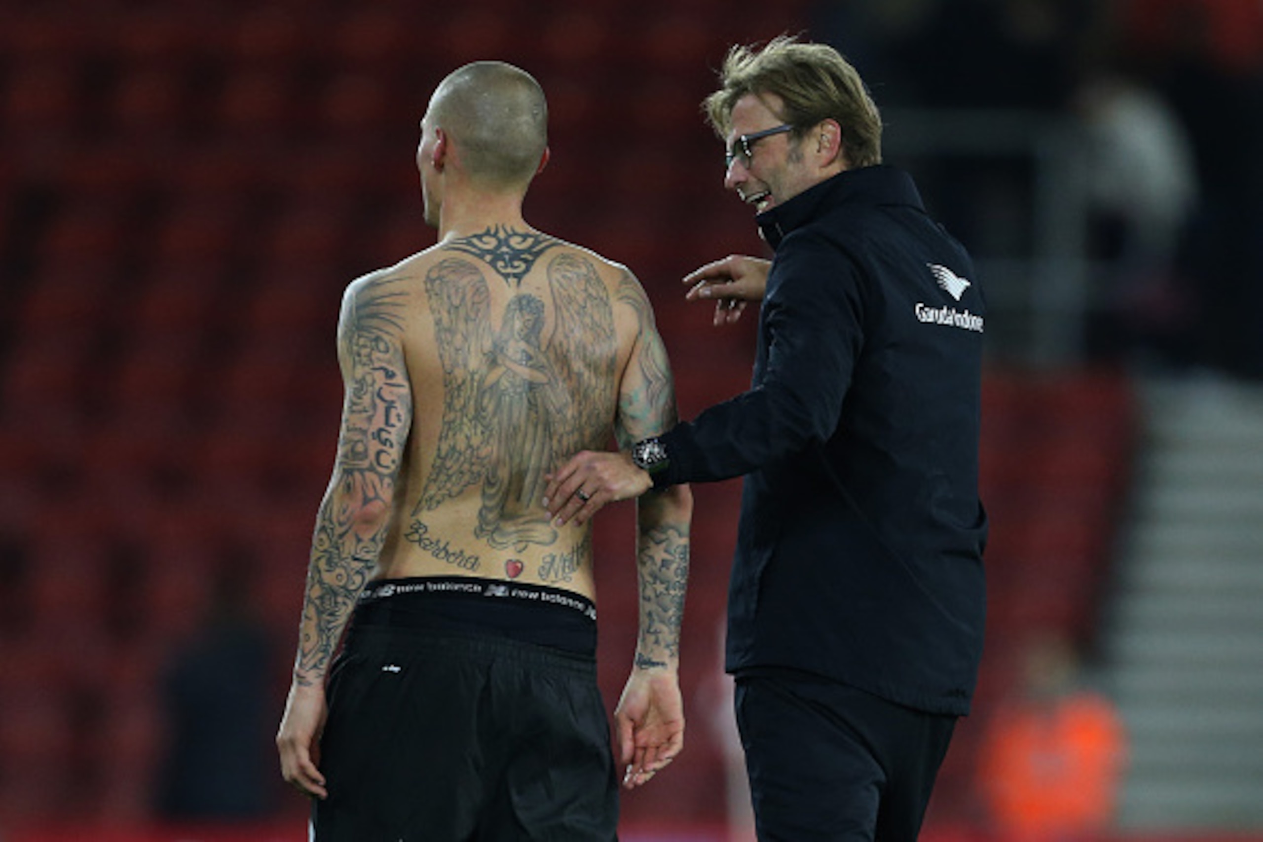 SOUTHAMPTON, ENGLAND - DECEMBER 02: Martin Skrtel of Liverpool has his tattoos on show as he talks to Jurgen Klopp manager of Liverpool after the Capital One Cup Quarter Final between Southampton and Liverpool at St Mary's Stadium on December 2, 2015 in S