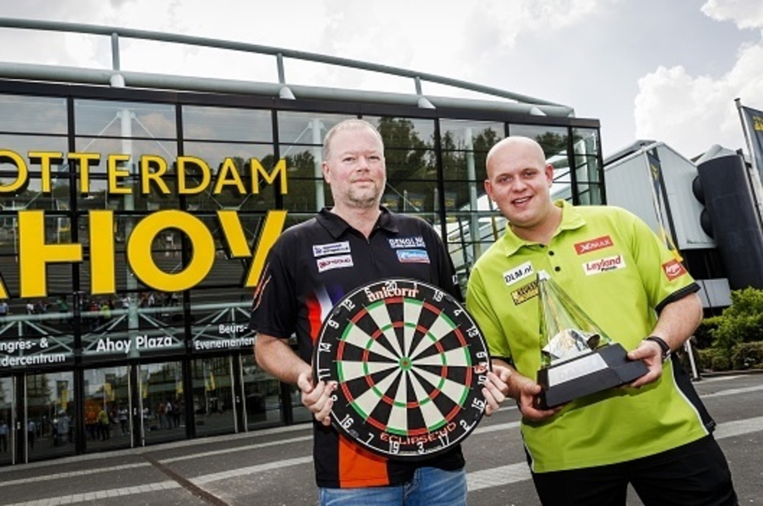 Dutch professional darts players Raymond van Barneveld (L) and Michael van Gerwen pose on May 11, 2016 as part of the press conference of the Premier League Darts in Rotterdam. 
The Premier League Darts is held on May 12 in Ahoy Rotterdam. / AFP / ANP / R