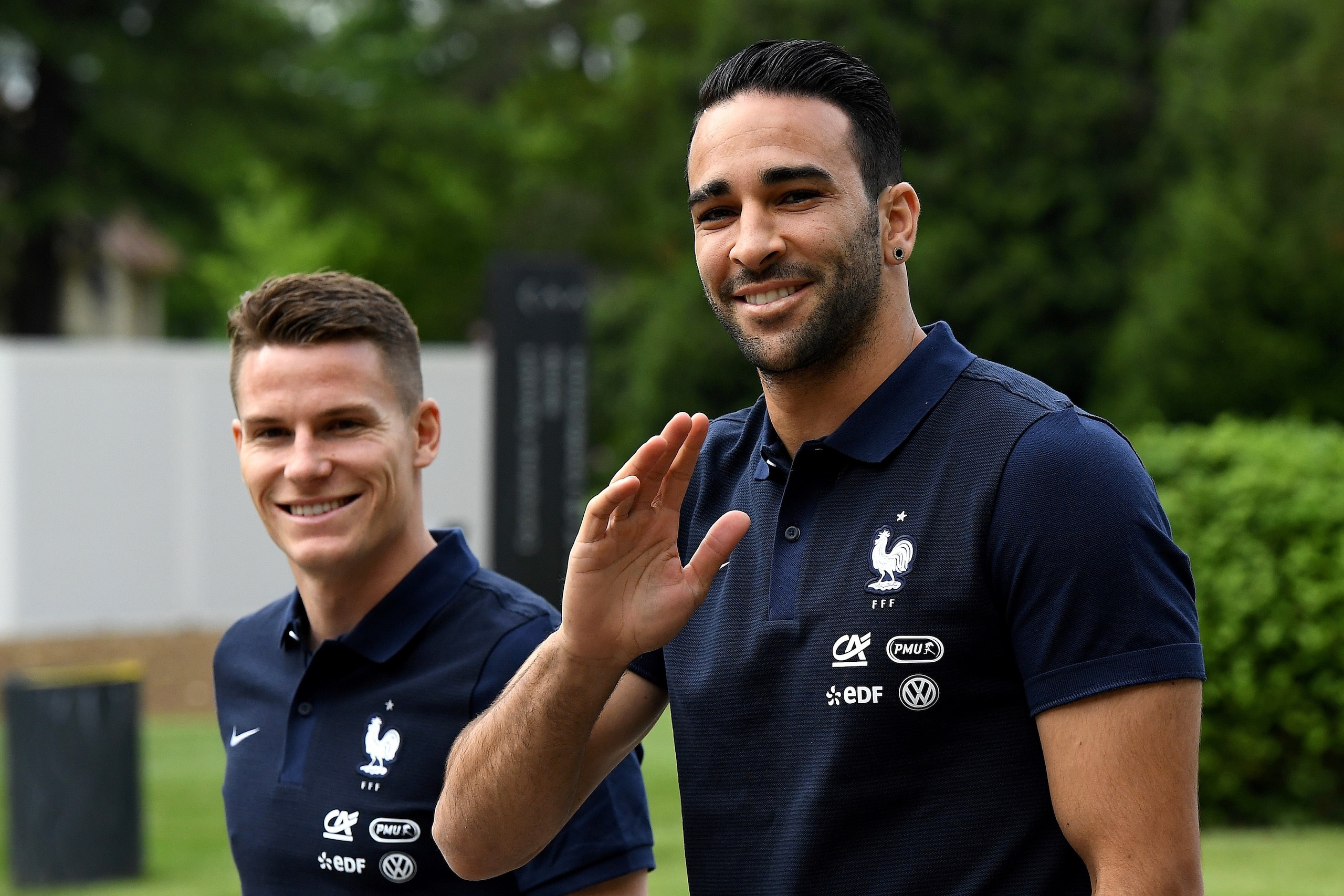 France's forward Kevin Gameiro (L) and defender Adil Rami walk at the French national football team training base in Clairefontaine on May 24, 2016, as part of the team's preparation for the upcoming Euro 2016 European football championships. / AFP / FRAN