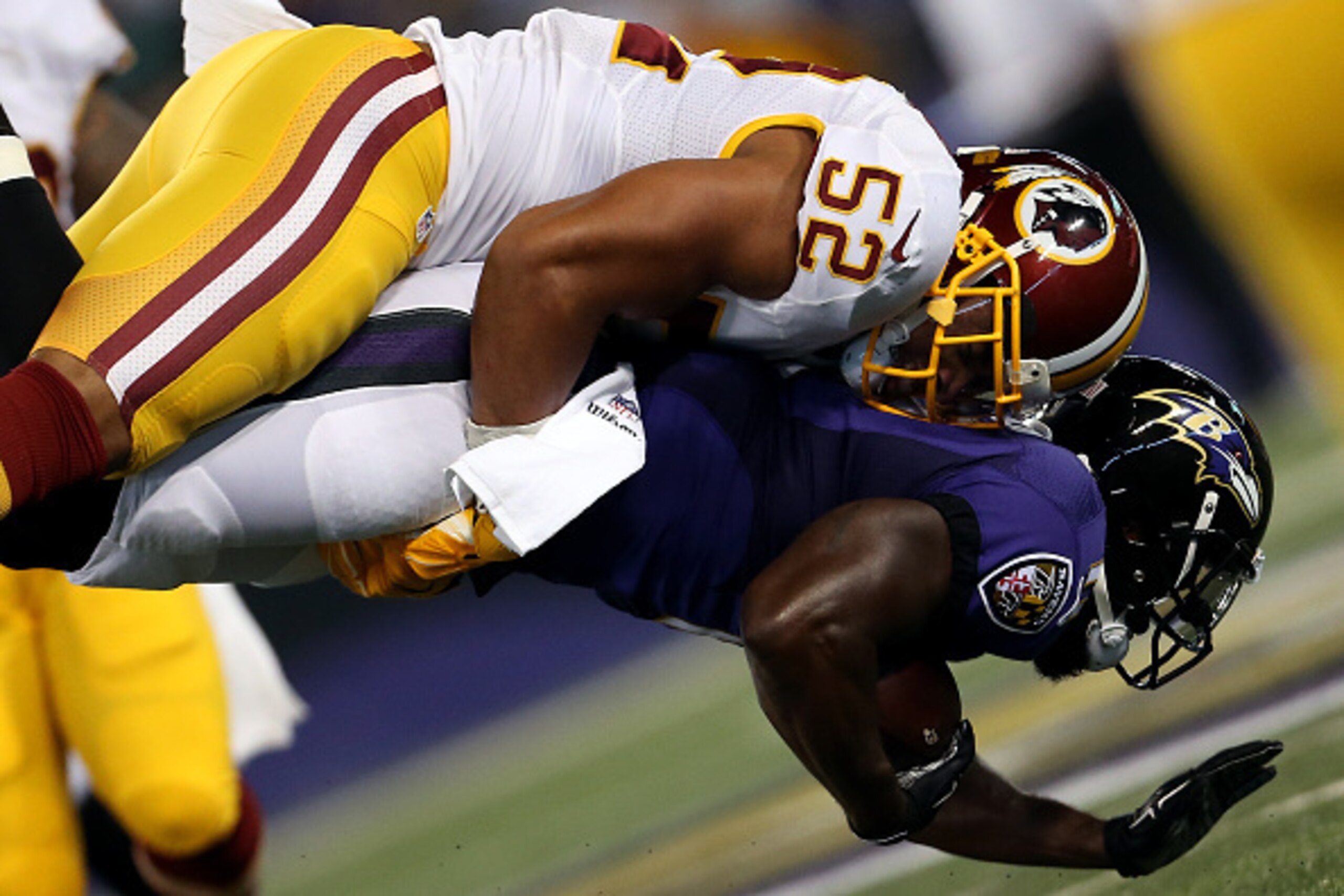 BALTIMORE, MD - AUGUST 29: Inside linebacker Keenan Robinson #52 of the Washington Redskins tackles wide receiver Kamar Aiken #11 of the Baltimore Ravens in the first quarter of a preseason game at M&T Bank Stadium on August 29, 2015 in Baltimore, Marylan
