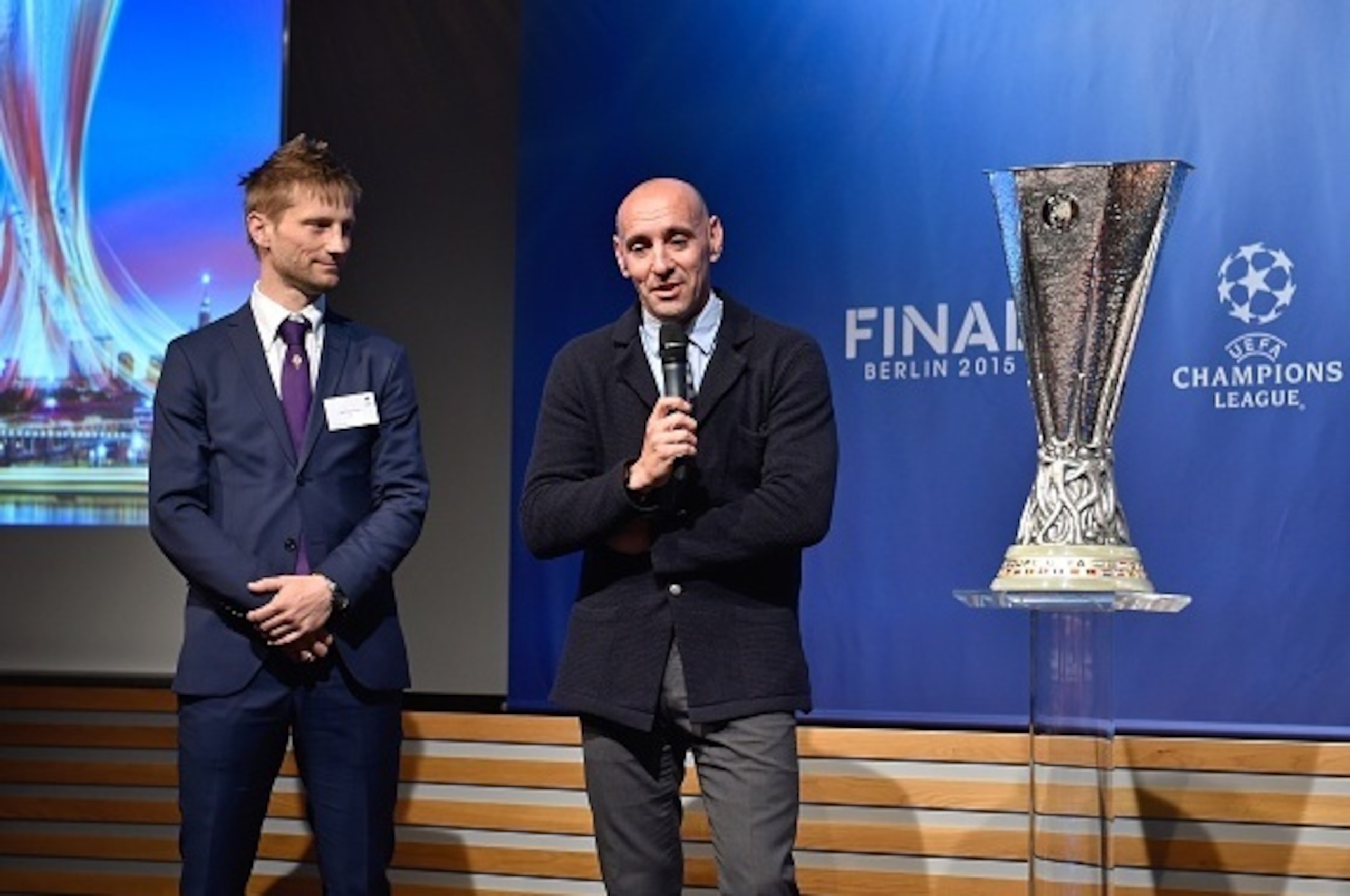 Retired Danish midfielder and Fiorentina representative, Martin Jorgensen (L) and former Spanish goalkeeper Ramon Rodriguez Verdejo, aka Monchi, and Sevilla representative react on stage after the draw for the UEFA Europa League semi-final football matche