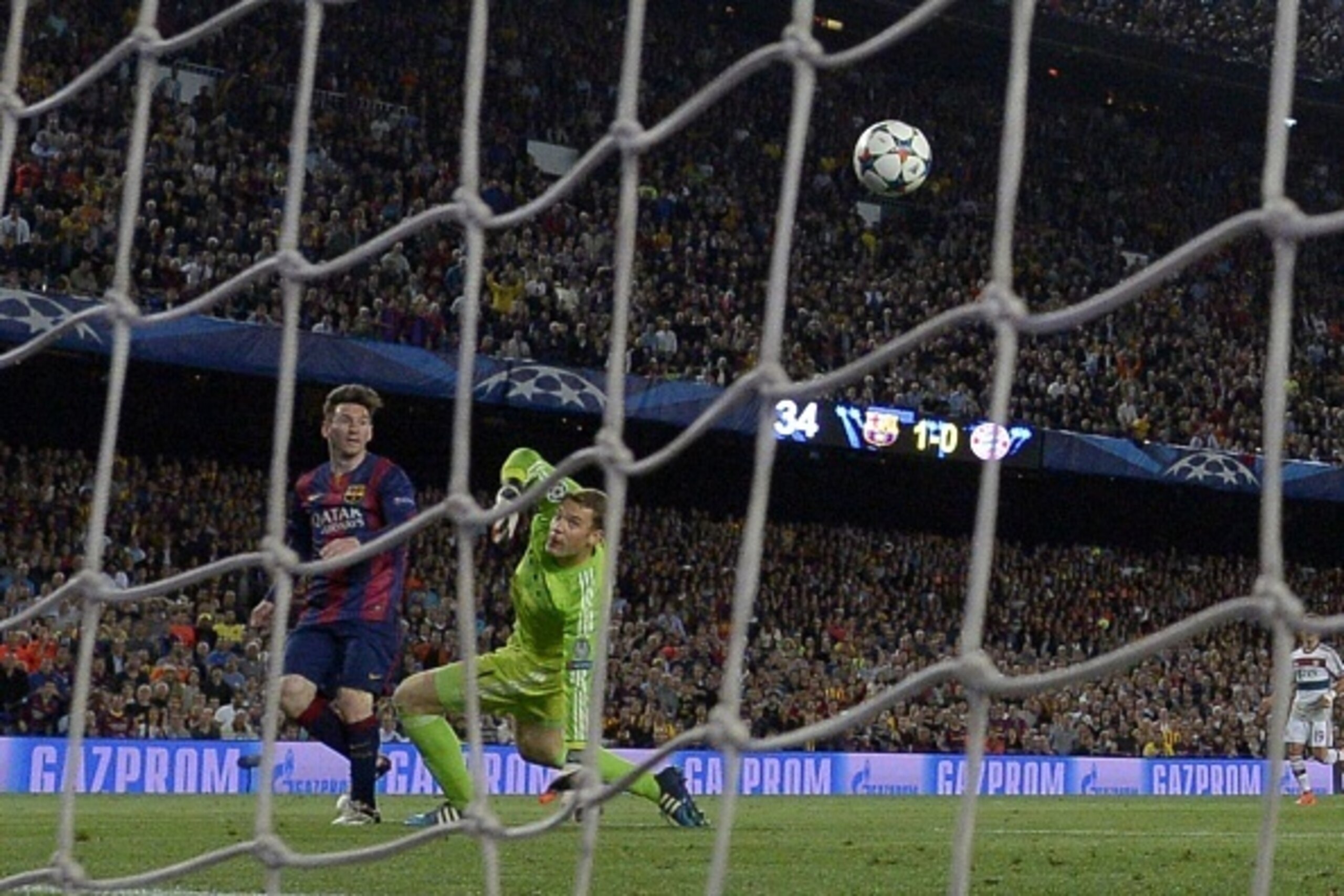 Barcelona's Argentinian forward Lionel Messi (L) scores his second goal during the UEFA Champions League football match FC Barcelona vs FC Bayern Muenchen at the Camp Nou stadium in Barcelona on May 6, 2015.     AFP PHOTO/ LLUIS GENE        (Photo credit 