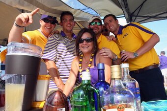 ARLINGTON, TX - AUGUST 31:  LSU Tigrs fans pose for a photo while tailgating before a game against the TCU Horned Frogs at AT&T Stadium on August 31, 2013 in Arlington, Texas.  (Photo by Ronald Martinez/Getty Images)