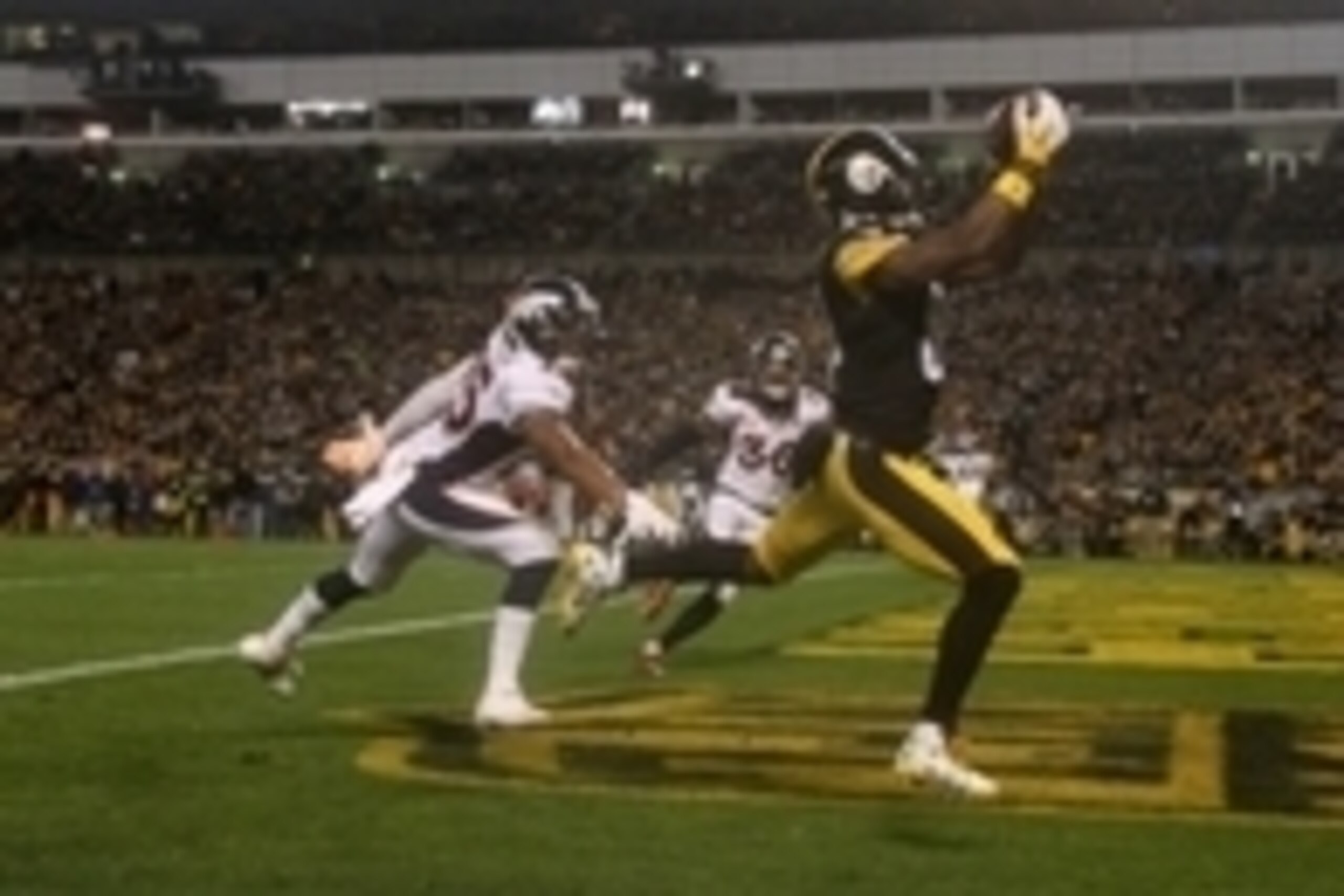 Dec 20, 2015; Pittsburgh, PA, USA; Pittsburgh Steelers wide receiver Antonio Brown (84) catches a touchdown pass in front of Denver Broncos cornerback Chris Harris Jr (25) during the second half at Heinz Field. The Steelers won the game 34-27. Mandatory C