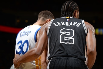 OAKLAND, CA - APRIL 7:  Stephen Curry #30 of the Golden State Warriors and Kawhi Leonard #2 of the San Antonio Spurs stand on the court during the game on April 7, 2016 at ORACLE Arena in Oakland, California. NOTE TO USER: User expressly acknowledges and