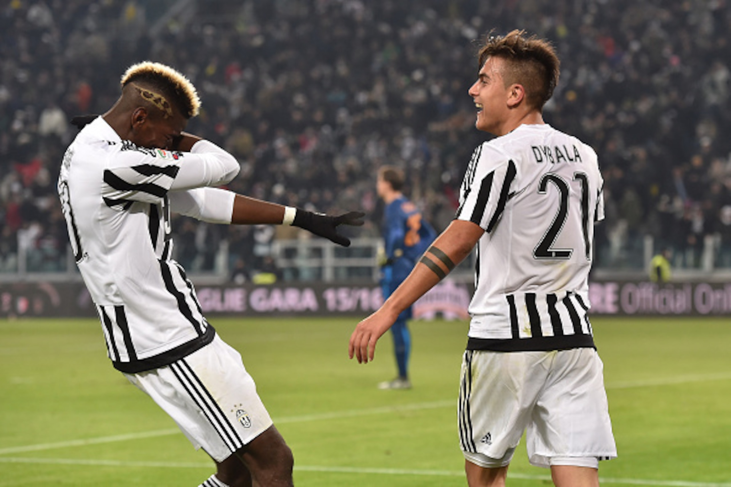 TURIN, ITALY - JANUARY 24:  Paulo Dybala (R) of Juventus FC celebrates after scoring the opening goal with team mate Paul Pogba during the Serie A match between Juventus FC and AS Roma at Juventus Arena on January 24, 2016 in Turin, Italy.  (Photo by Vale