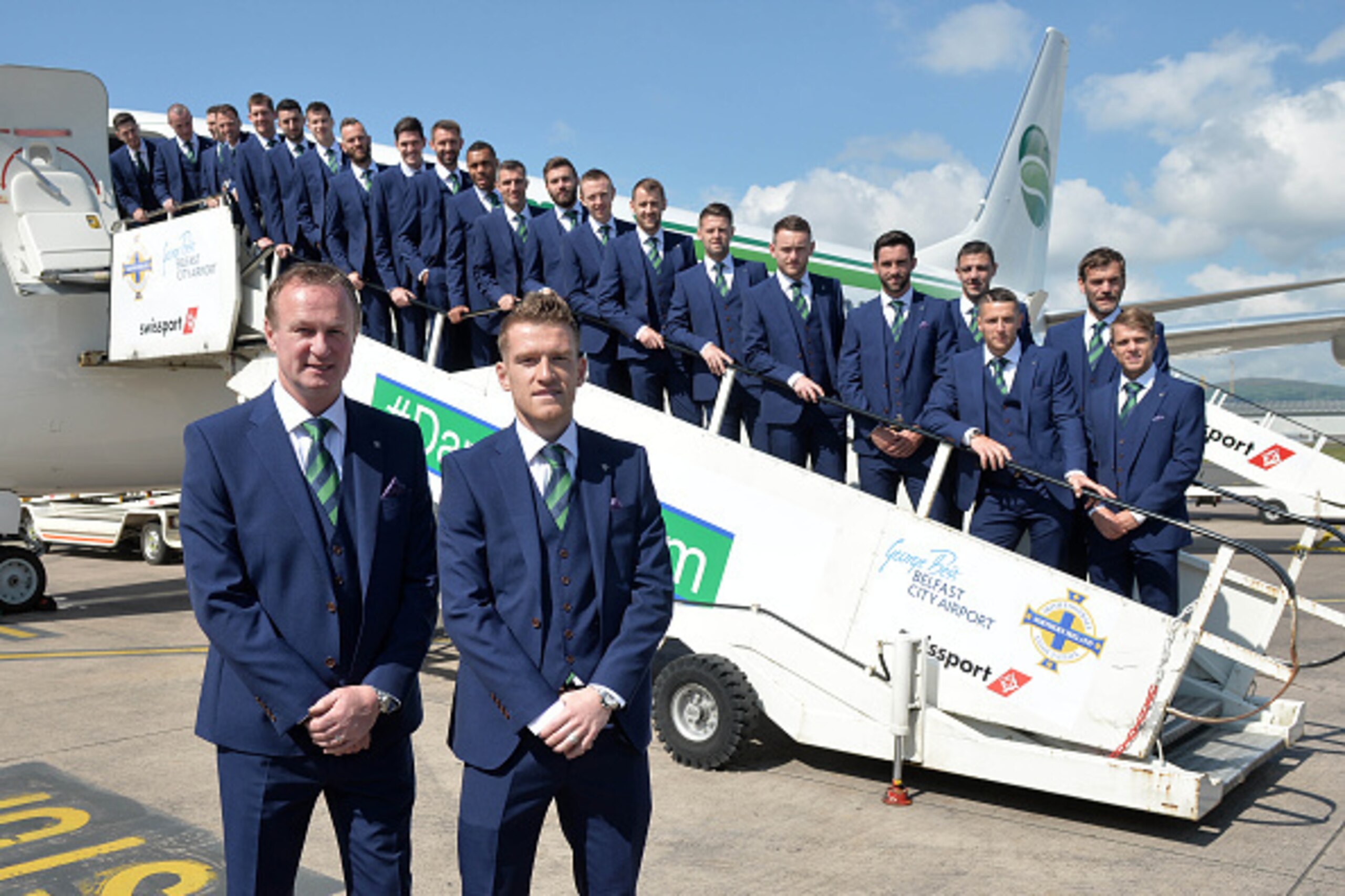 BELFAST, NORTHERN IRELAND - MAY 30: Manager Michael O'Neill (L) and captain Steve Davis (R) with the Northern Ireland team as they pose for an official photograph before their training camp departure at George Best City Airport on May 30, 2016 in Belfast,