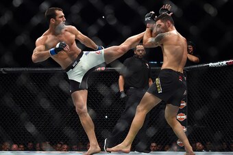 LAS VEGAS, NEVADA - DECEMBER 12:  (L-R) Luke Rockhold kicks Chris Weidman in their middleweight championship bout during the UFC 194 event inside MGM Grand Garden Arena on December 12, 2015 in Las Vegas, Nevada.  (Photo by Jeff Bottari/Zuffa LLC/Zuffa LLC