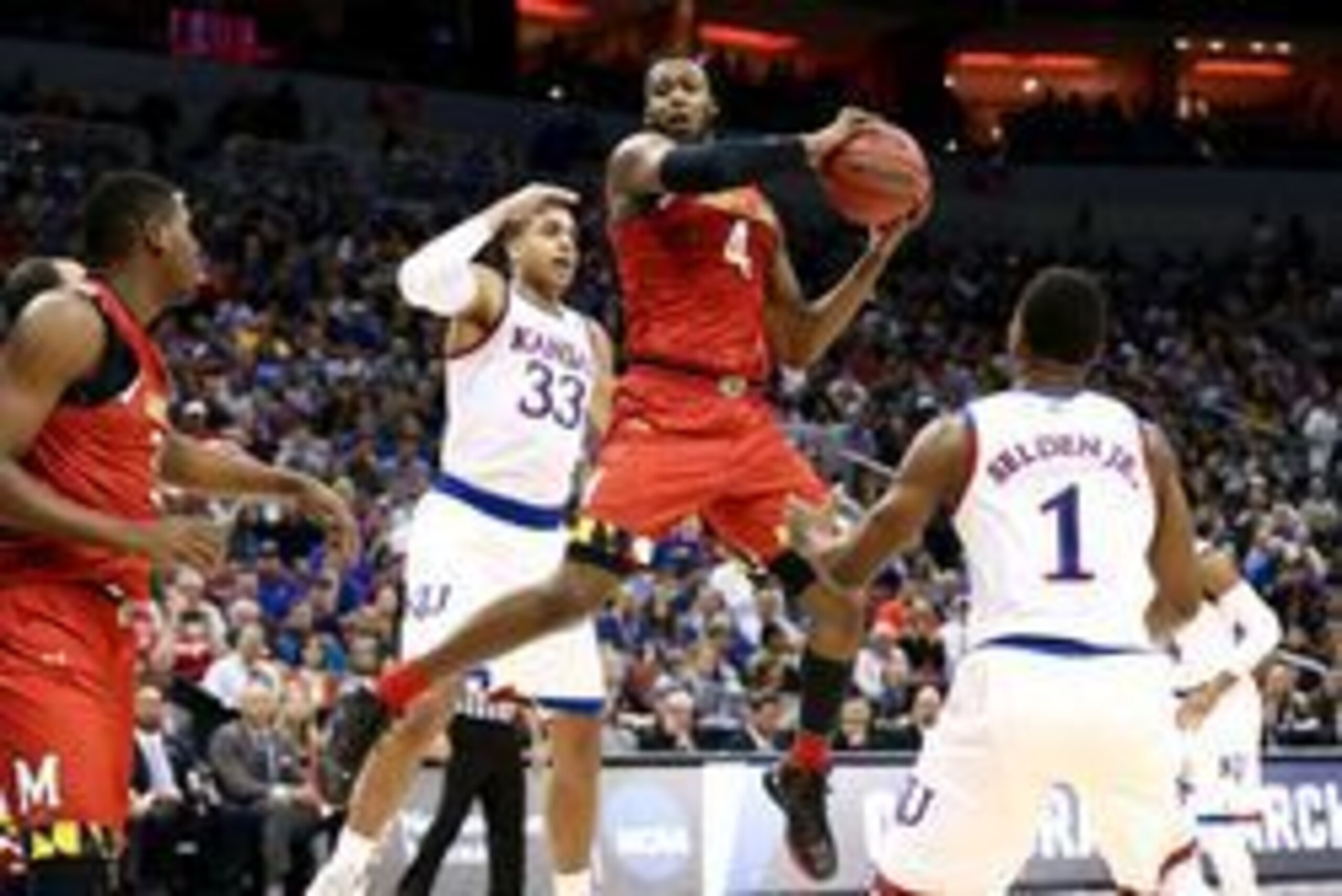 Mar 24, 2016; Louisville, KY, USA; Maryland Terrapins forward Robert Carter (4) grabs a rebound against Kansas Jayhawks forward Landen Lucas (33) during the first half in a semifinal game in the South regional of the NCAA Tournament at KFC YUM!. Mandatory