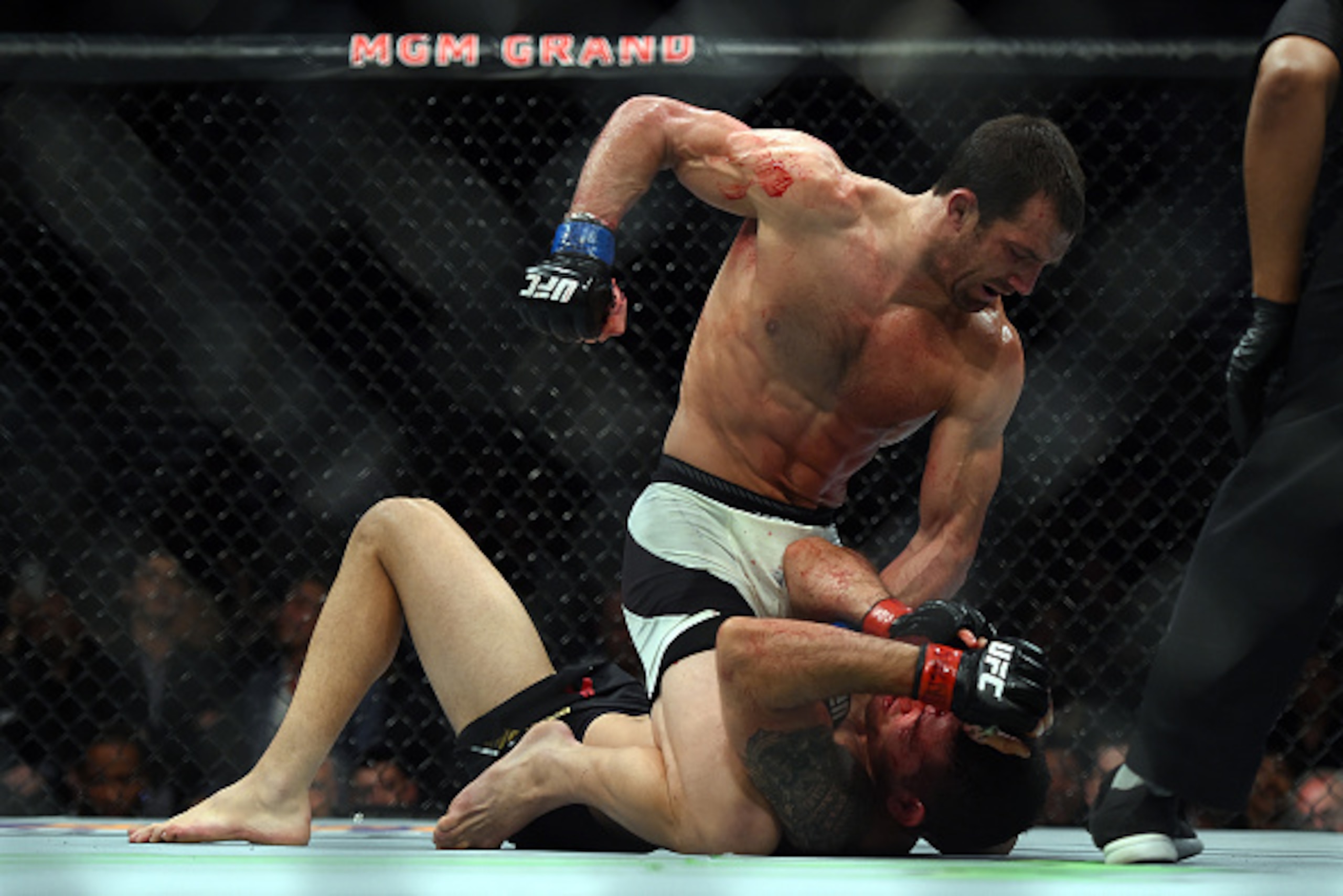 LAS VEGAS, NEVADA - DECEMBER 12:  (L-R) Luke Rockhold punches Chris Weidman in their middleweight championship bout during the UFC 194 event inside MGM Grand Garden Arena on December 12, 2015 in Las Vegas, Nevada.  (Photo by Jeff Bottari/Zuffa LLC/Zuffa L