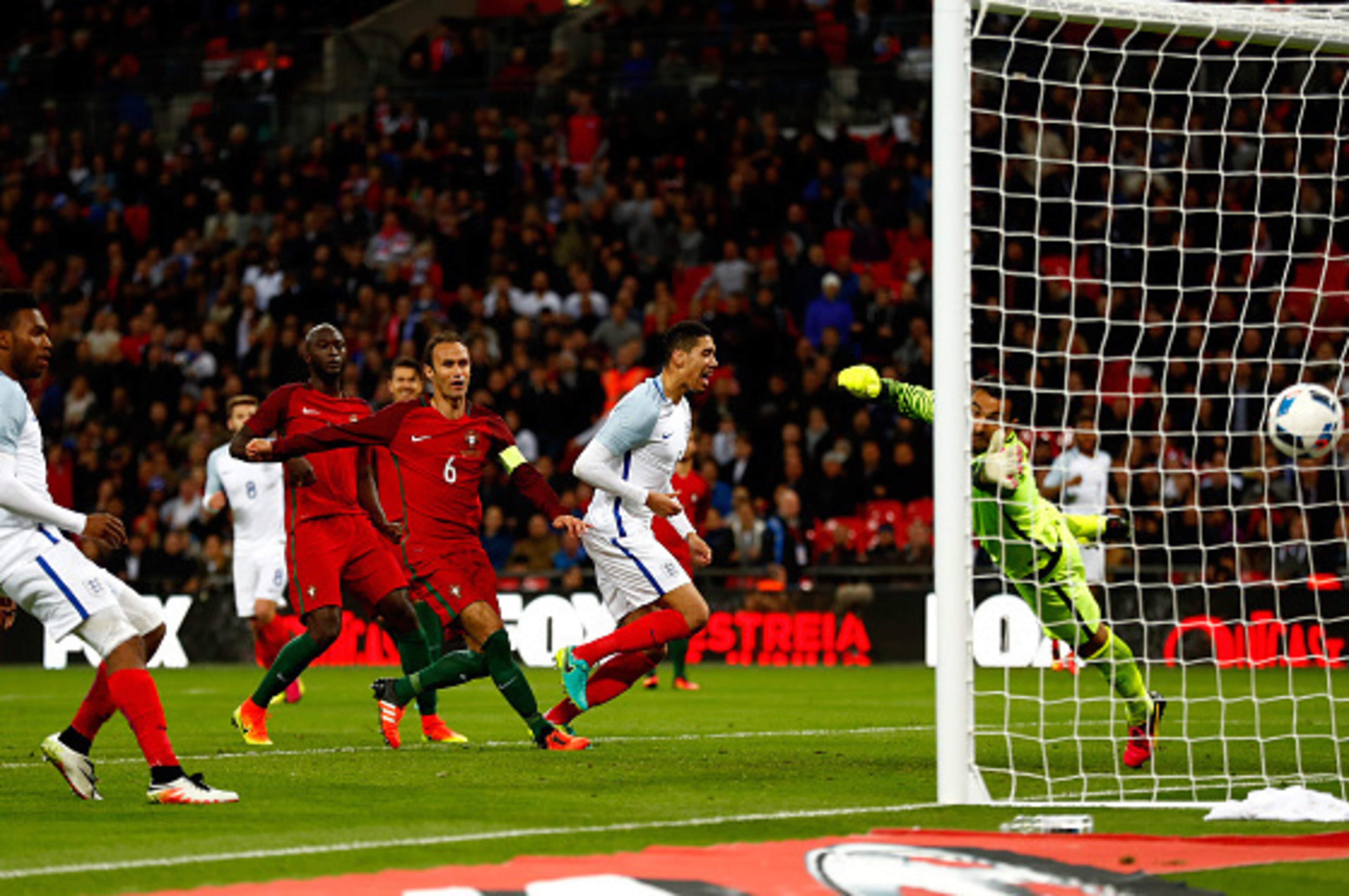 LONDON, ENGLAND - JUNE 02:  Chris Smalling of England (6) beats goalkeeper Rui Patricio of Portugal as he scores their first goal during the international friendly match between England and Portugal at Wembley Stadium on June 2, 2016 in London, England.  