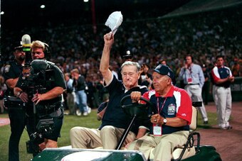 13 Jul 1999:  Ted Williams waves to the crowd as he is driven onto the field before the 1999 MLB All-Star Game against the National League Team and the American League Team at Fenway Park in Boston, Massachusetts. The American League Team defeated the Nat