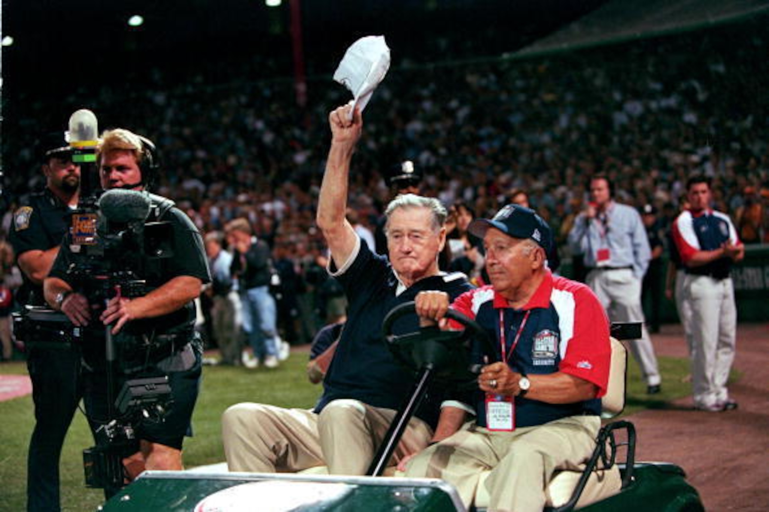 13 Jul 1999:  Ted Williams waves to the crowd as he is driven onto the field before the 1999 MLB All-Star Game against the National League Team and the American League Team at Fenway Park in Boston, Massachusetts. The American League Team defeated the Nat