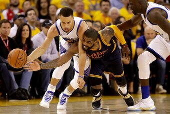 OAKLAND, CA - JUNE 02:  Stephen Curry #30 of the Golden State Warriors and Kyrie Irving #2 of the Cleveland Cavaliers go after the ball in the first half in Game 1 of the 2016 NBA Finals at ORACLE Arena on June 2, 2016 in Oakland, California. NOTE TO USER