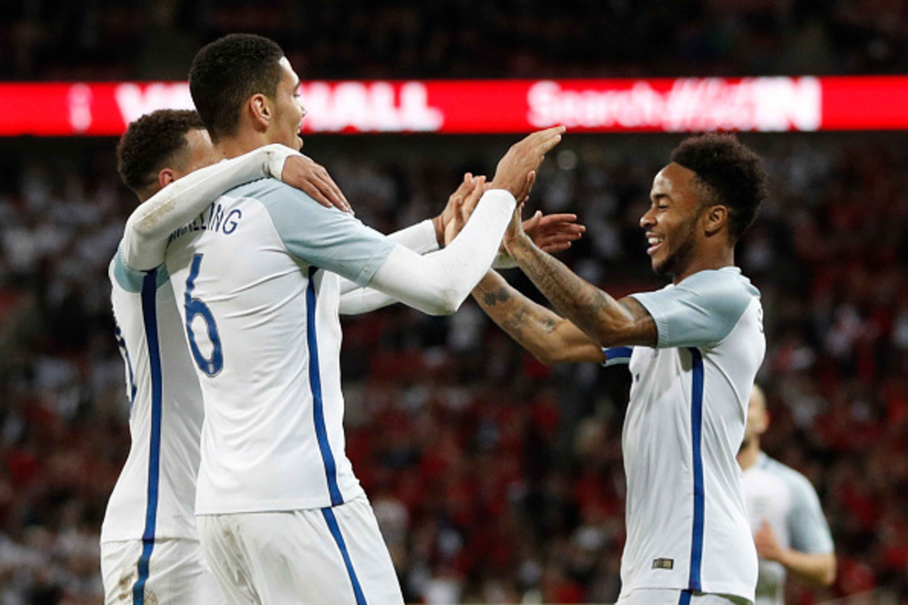 England's defender Chris Smalling (L) celebrates with England's midfielder Raheem Sterling after scoring during the friendly football match between England and Portugal at Wembley stadium in London on June 2, 2016.
 / AFP / ADRIAN DENNIS        (Photo cre
