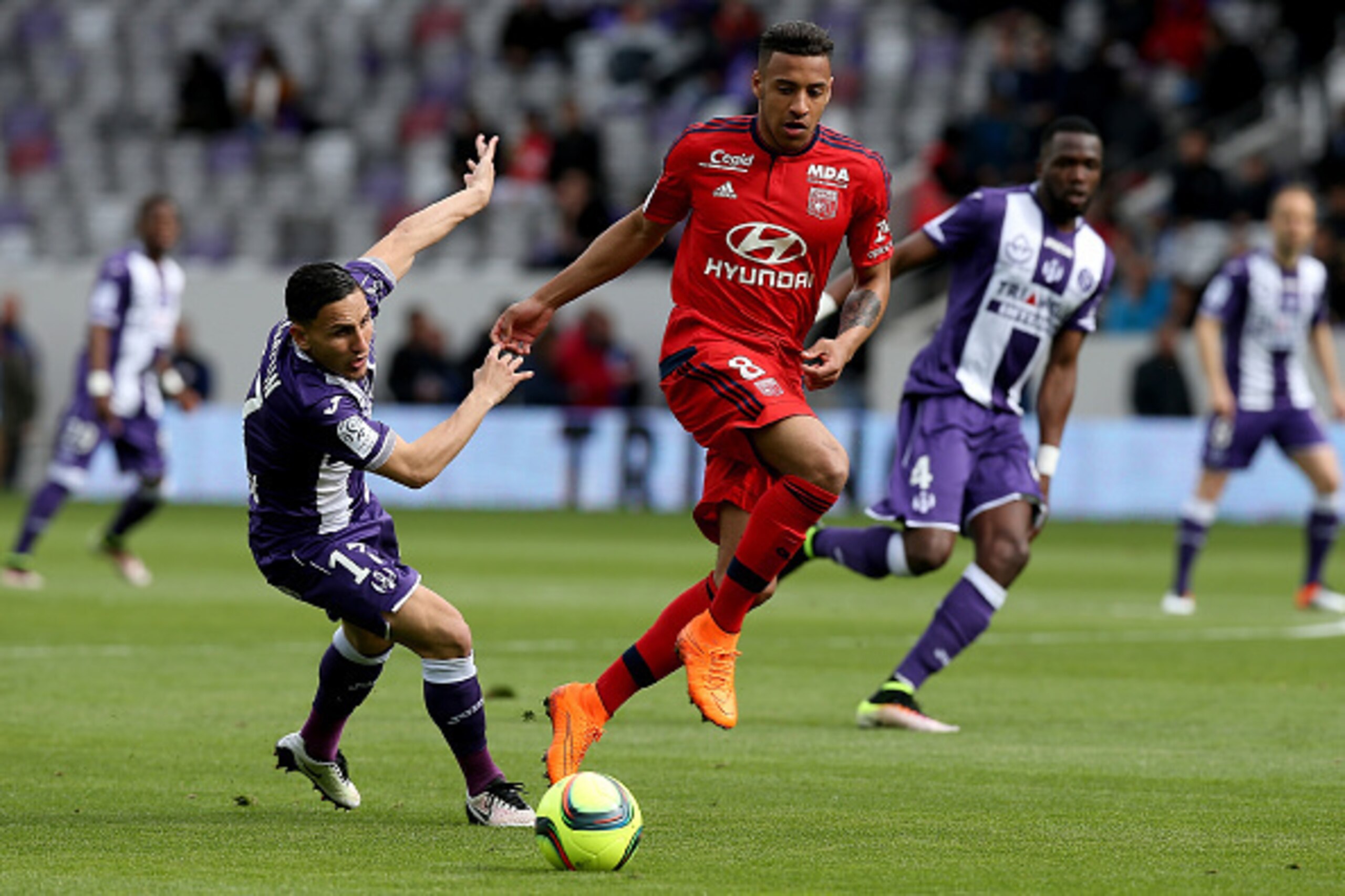 TOULOUSE, FRANCE - APRIL 23: Corentin Tolisso of Lyon and Adrien Regattin of Toulouse battle for the ball during the French Ligue 1 match between Toulouse and Lyon at Stadium Municipal on April 23, 2016 in Toulouse, France. (Photo by Romain Perrocheau/Get
