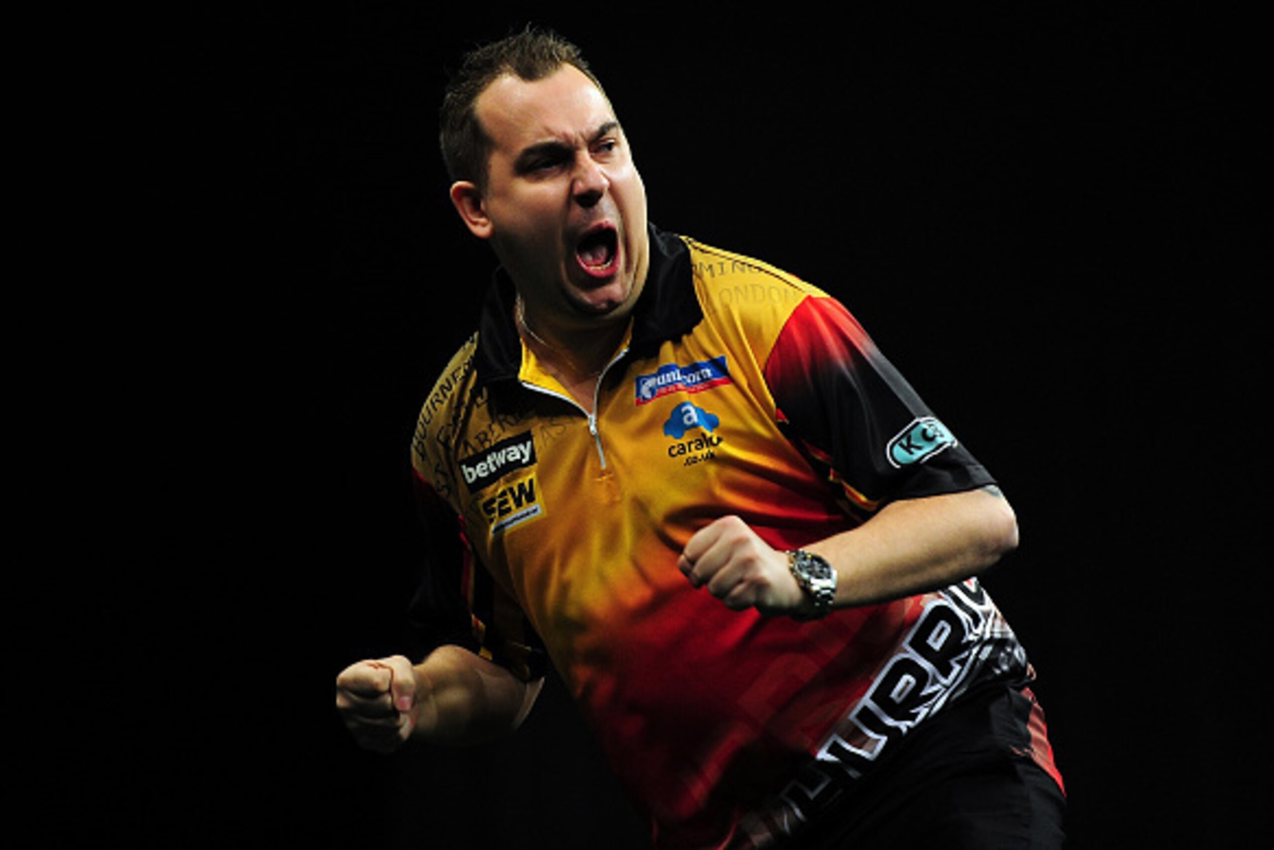 EXETER, ENGLAND - MARCH 05:  Kim Huybrechts of Belgium celebrates beating Raymond van Barneveld of Holland during The Betway Premier League Darts at Westpoint Arena on March 5, 2015 in Exeter, England.  (Photo by Dan Mullan/Getty Images)