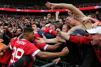 Manchester United's English striker Marcus Rashford (L) and Manchester United's English midfielder Jesse Lingard (R) celebrate with the crowd after Manchester United's French striker Anthony Martial scored their second goal during the English FA Cup semi-