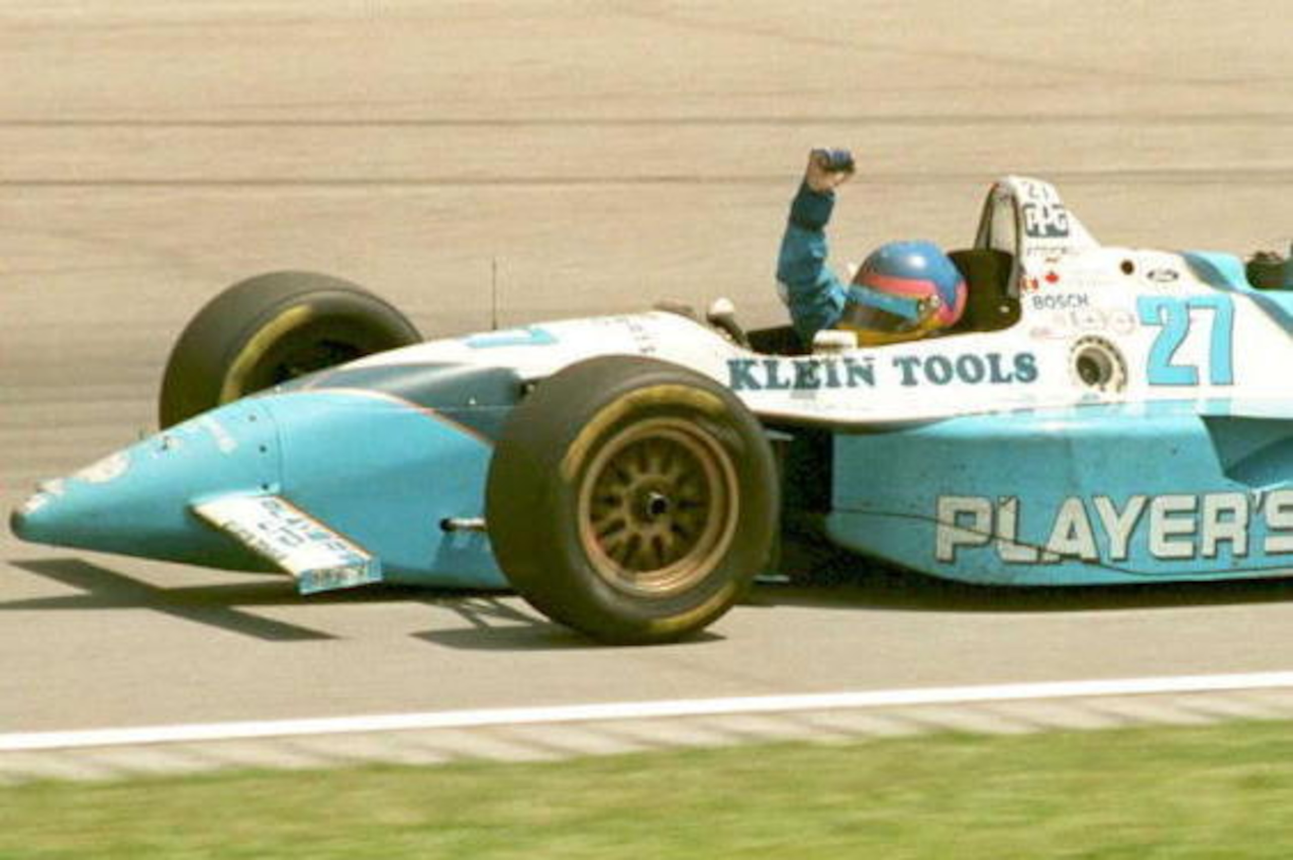 INDIANAPOLIS, UNITED STATES:  Canadian Indy car driver Jacques Villeneuve pumps his fist as he circles the track 28 May after winning the 79th Indianapolis 500. Villeneuve won the race in his second attempt.  AFP PHOTO (Photo credit should read JOHN MAXWE