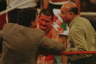 7 Jun 1996:  Ringside doctor Flip Homasky and referee Joe Cortez stop Julio Cesar Chavez from continuing the fight during his WBC Super Lightweight title bout verus Oscar De La Hoya at Caesars Palace in Las Vegas, Nevada.  De La Hoya won the bout with a d