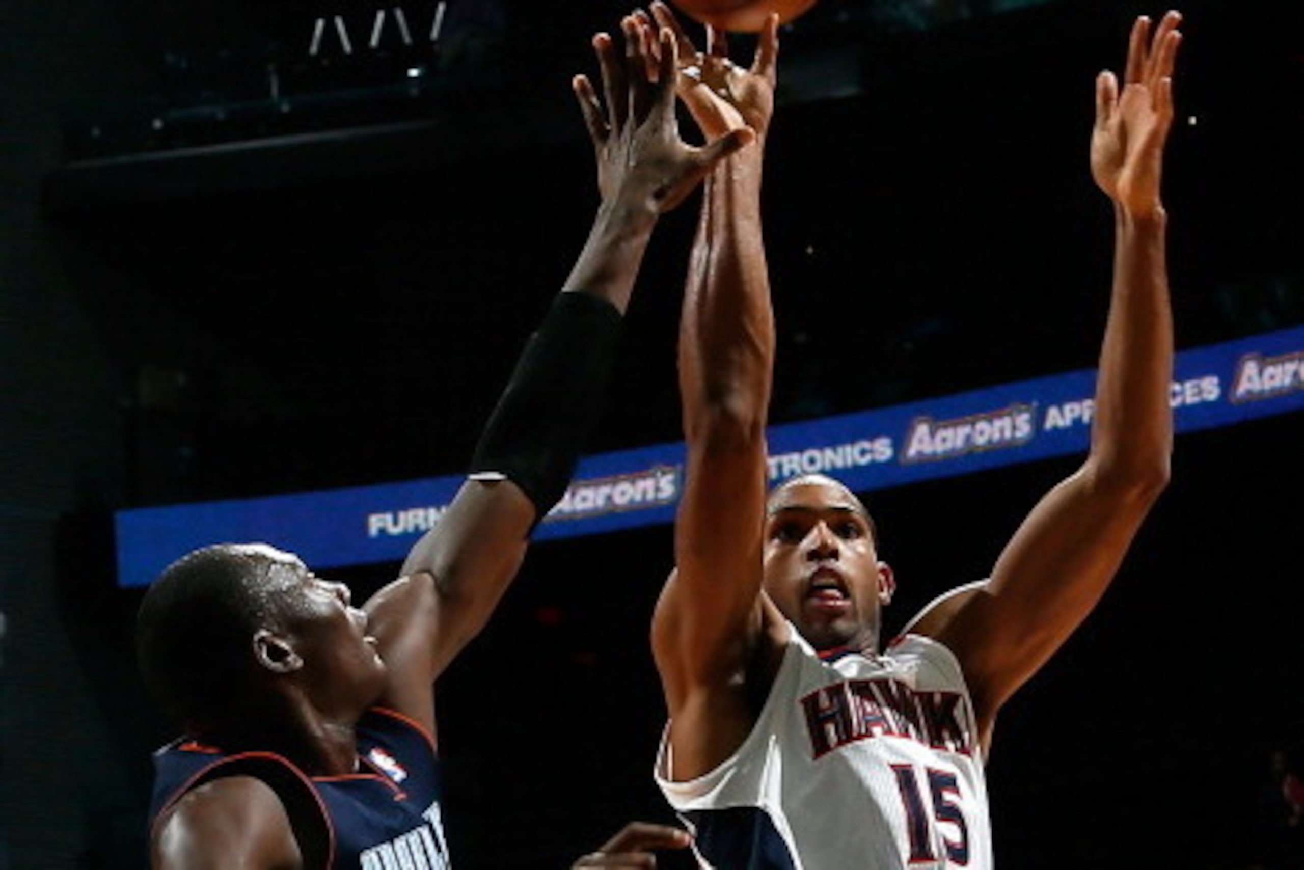 ATLANTA, GA - NOVEMBER 28:  Al Horford #15 of the Atlanta Hawks shoots against Bismack Biyombo #0 of the Charlotte Bobcats at Philips Arena on November 28, 2012 in Atlanta, Georgia.  NOTE TO USER: User expressly acknowledges and agrees that, by downloadin