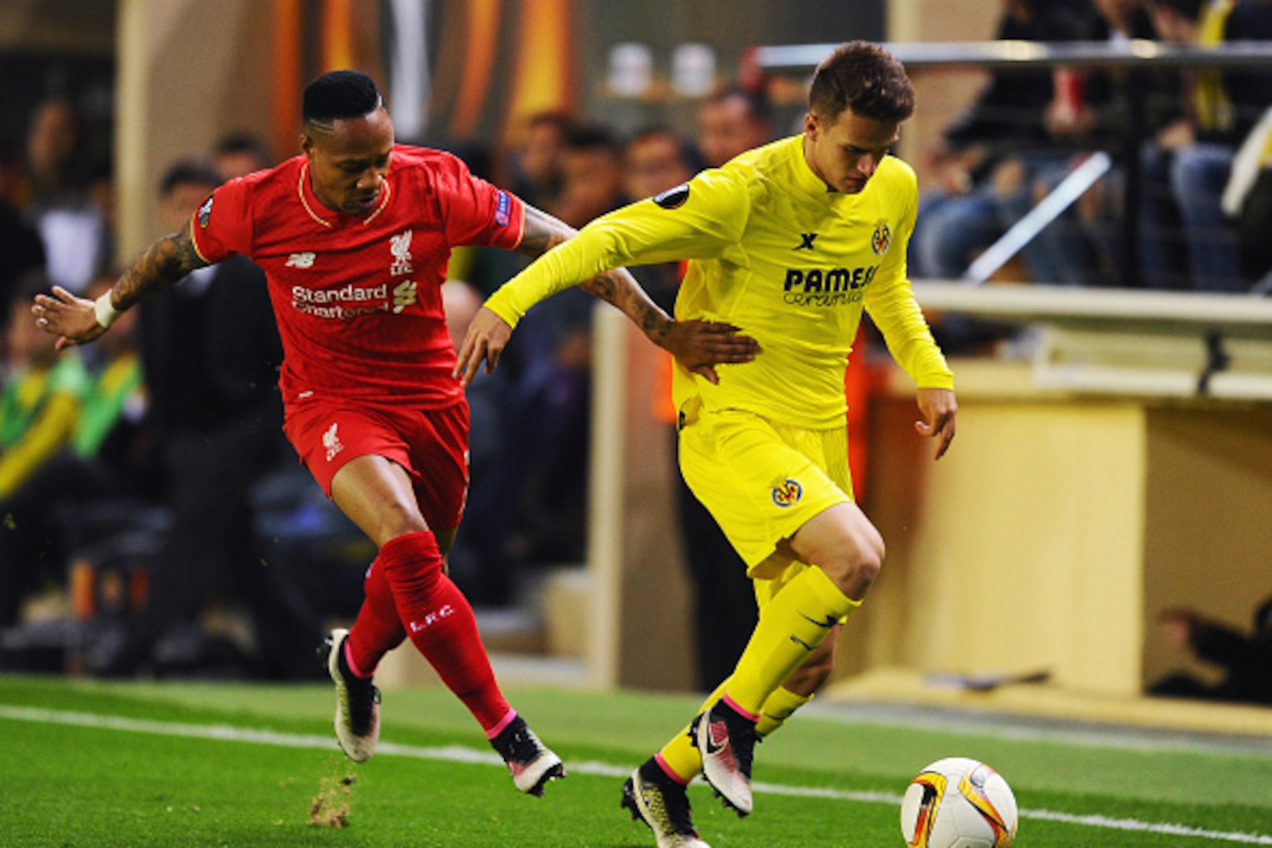 VILLARREAL, SPAIN - APRIL 28:  Denis Suarez of Villarreal holds off Nathaniel Clyne of Liverpool during the UEFA Europa League semi final first leg match between Villarreal CF and Liverpool at Estadio El Madrigal on April 28, 2016 in Villarreal, Spain.  (