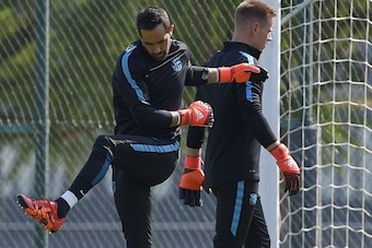 Barcelona's Chilean goalkeeper Claudio Bravo (L) and Barcelona's German goalkeeper Marc-Andre Ter Stegen (R) take part in a training session at the Sports Center FC Barcelona Joan Gamper in Sant Joan Despi, near Barcelona on September 28, 2015, on the eve