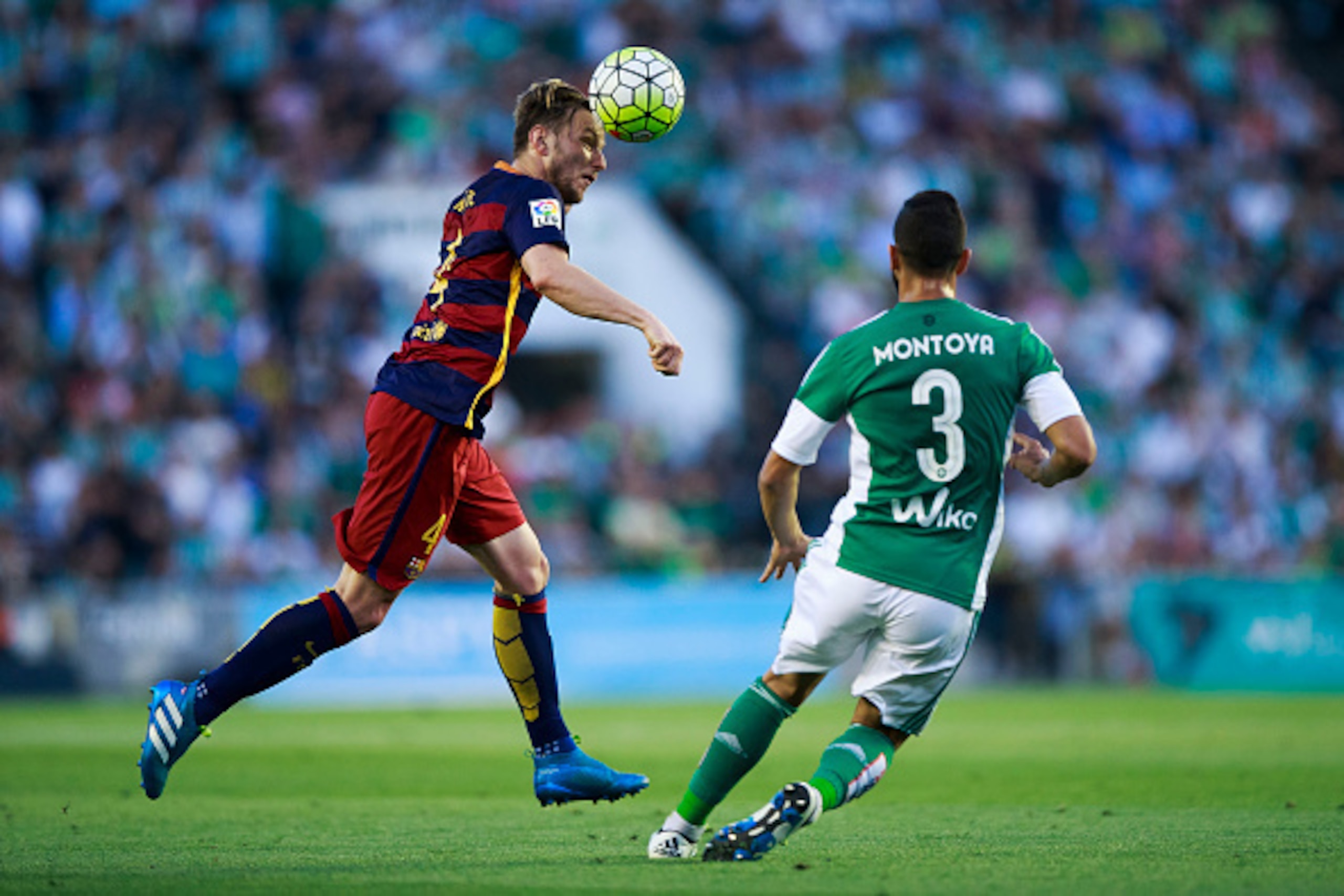 SEVILLE, SPAIN - APRIL 30: Ivan Rakitic of FC Barcelona wins the header before Martin Montoya of Real Betis Balompie during the La Liga match between Real Betis Balompie and FC Barcelona at Estadio Benito Villamarin on April 30, 2016 in Seville, Spain.  (