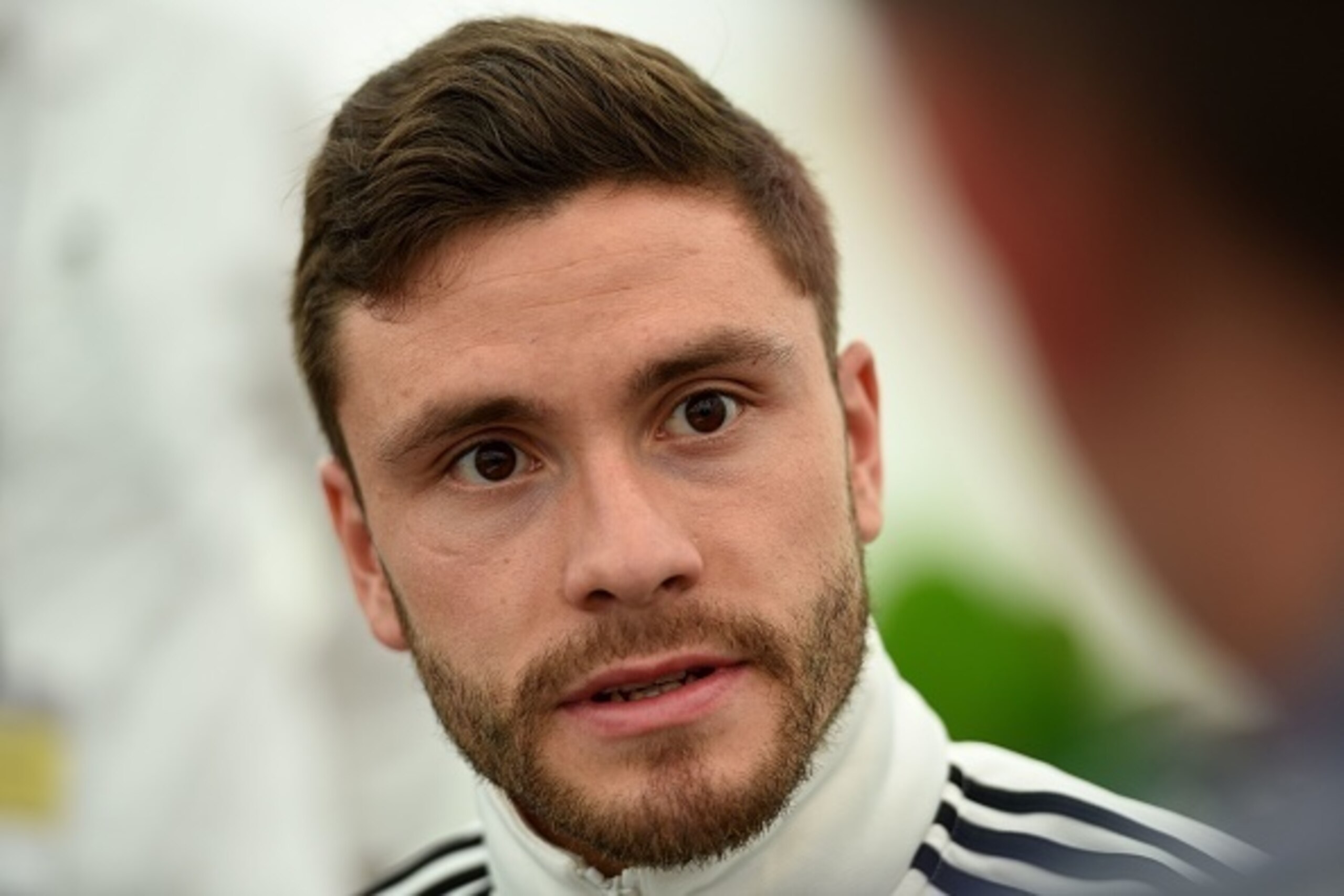 Germany's defender Jonas Hector gives interviews during a press meeting after a training session as part of the team's preparation for the upcoming Euro 2016 European football championship, in Ascona on June 2, 2016. / AFP / PATRIK STOLLARZ        (Photo 