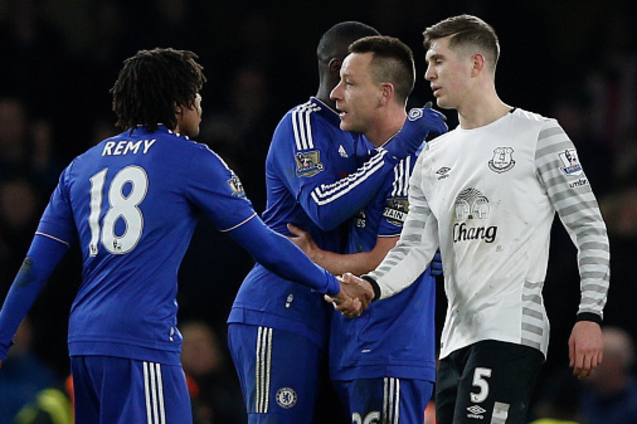 Everton's English defender John Stones (R) shakes hands with Chelsea's French striker Loic Remy (L) at the end of the English Premier League football match between Chelsea and Everton at Stamford Bridge in London on January 16, 2016. AFP PHOTO / ADRIAN DE