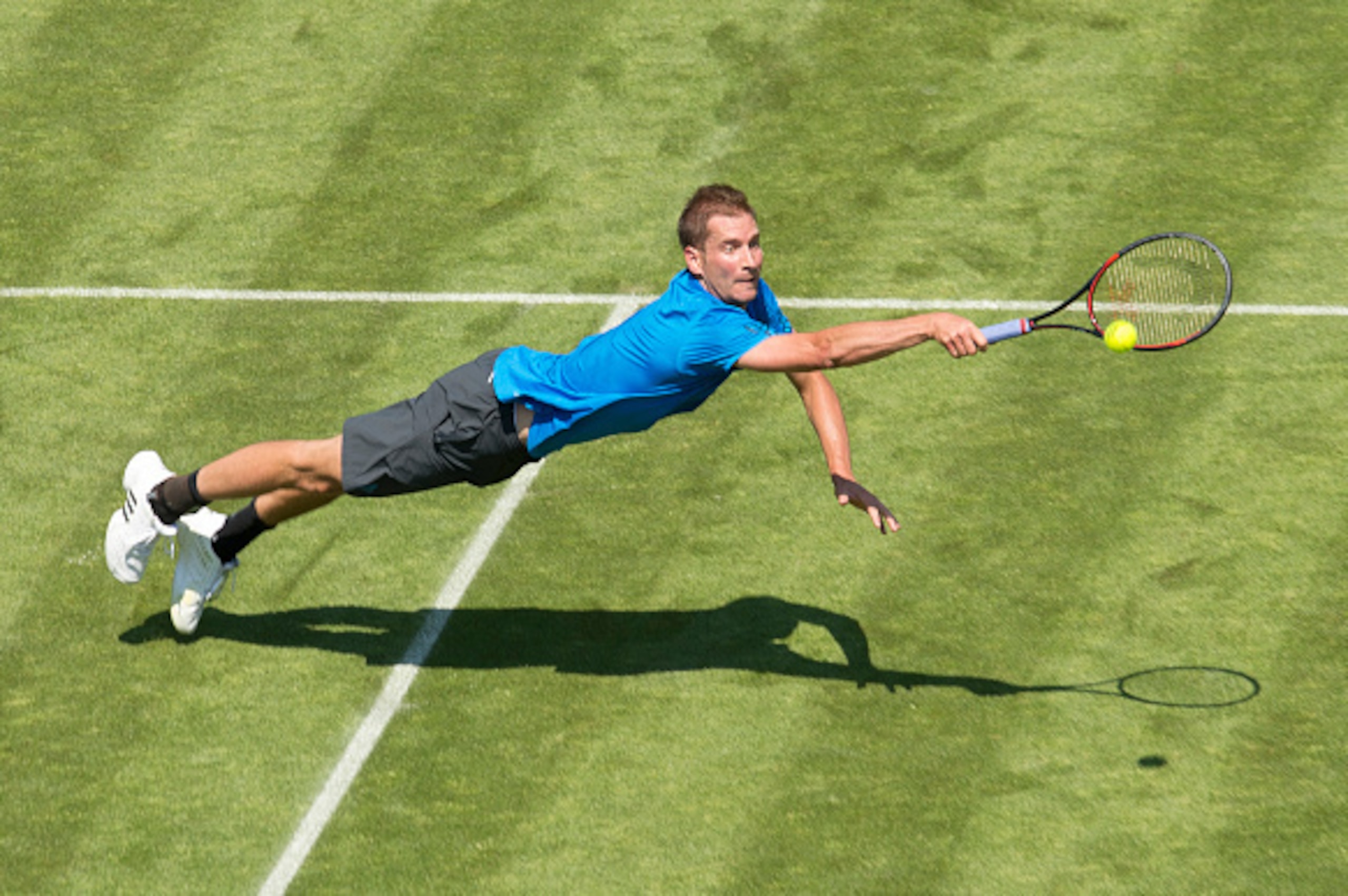 Germany's Florian Mayer dives for the ball during his match against compatriot Matthias Bachinger at the ATP Mercedes Cup tennis tournament in Stuttgart, southern Germany, on June 6, 2016.      / AFP / THOMAS KIENZLE        (Photo credit should read THOMA