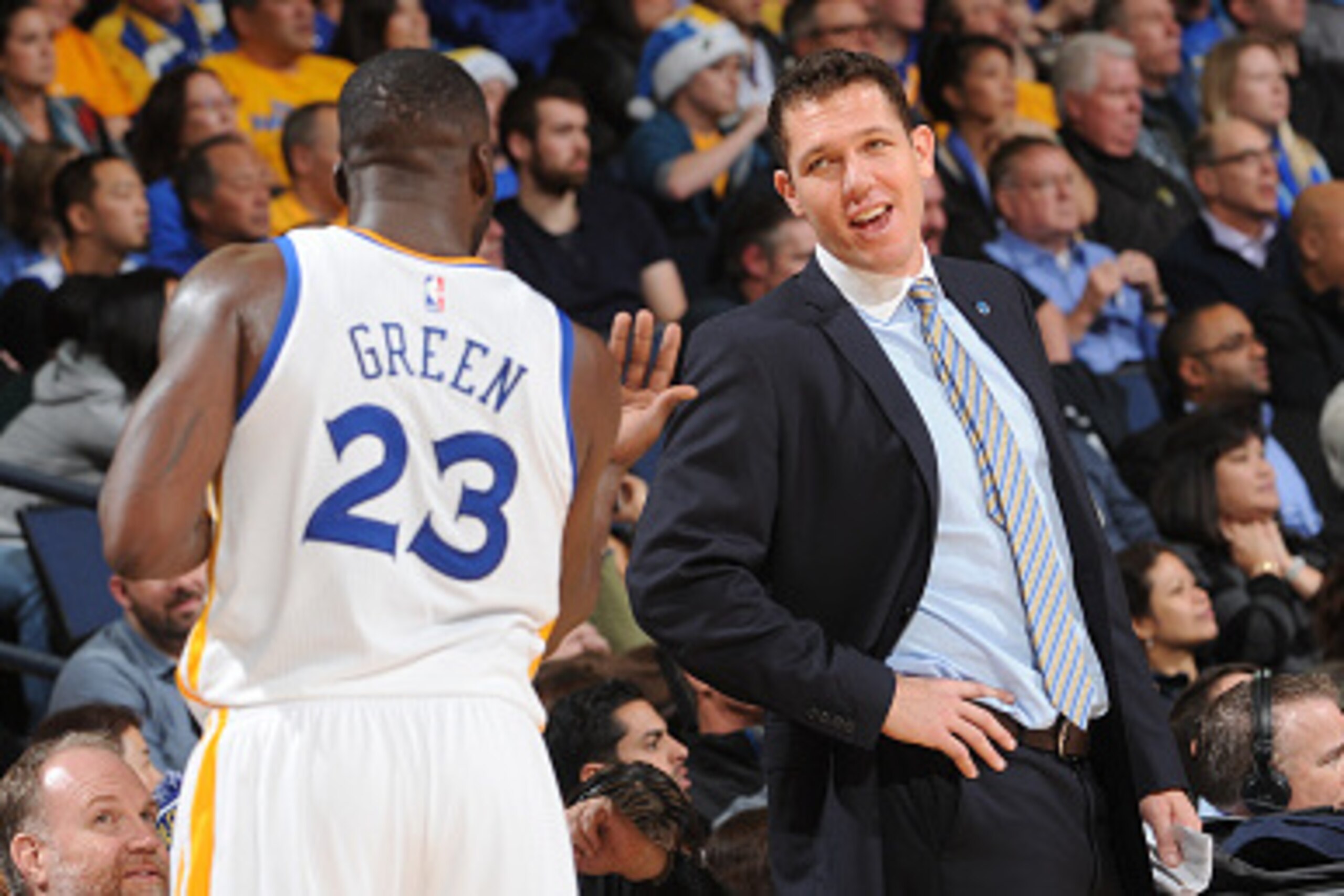 OAKLAND, CA - JANUARY 4: Draymond Green #23 chats with Interim Head coach Luke Walton of the Golden State Warriors while facing the Charlotte Hornets on January 4, 2016 at Oracle Arena in Oakland, California. NOTE TO USER: User expressly acknowledges and 