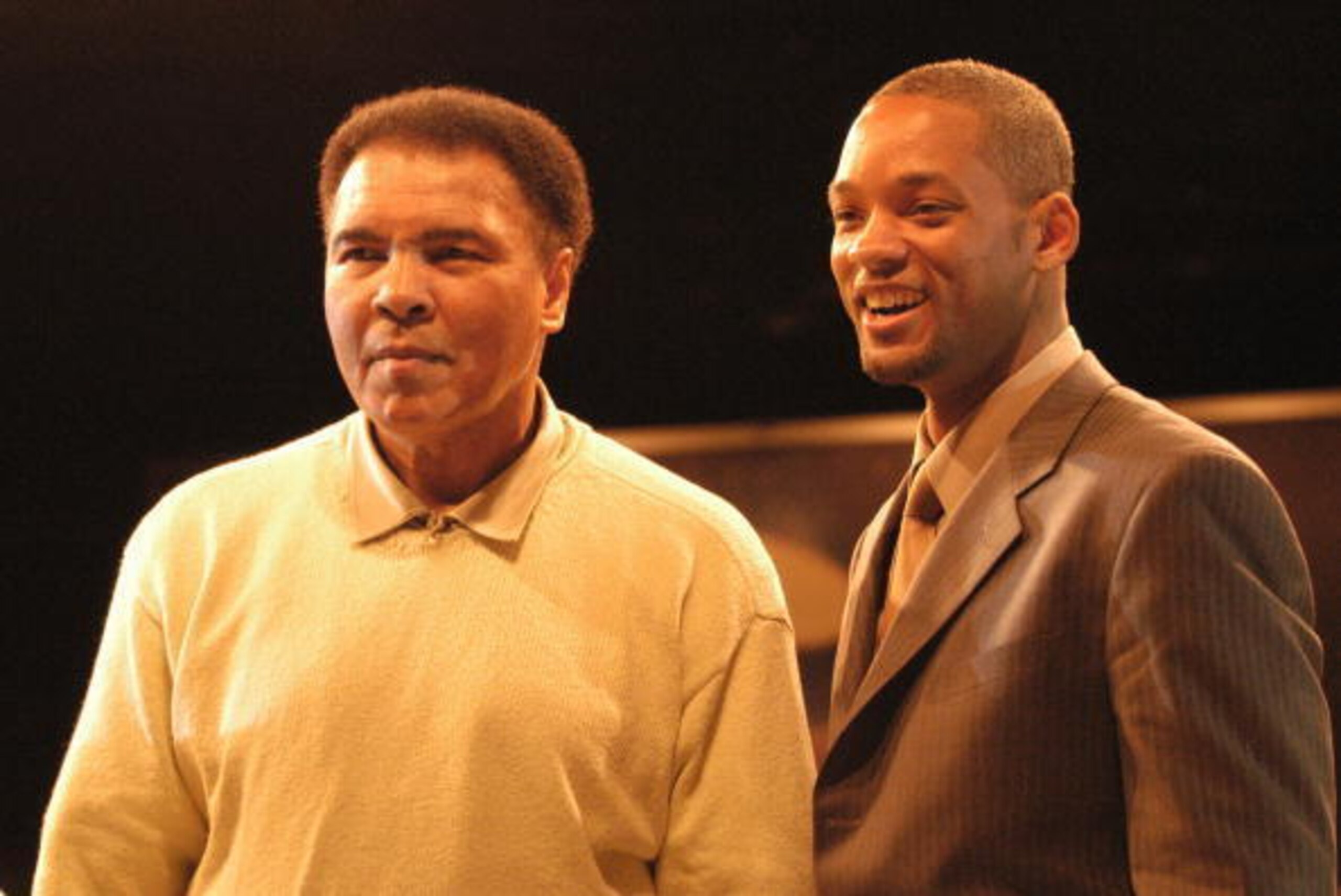 MIAMI - DECEMBER 6:  Boxing legend Muhammad Ali (L) stands with actor Will Smith at the Miami Art Basel Taschen book premiere of Ali's new book, 'GOAT - Greatest Of All Time' at the Miami Convention Center December 6, 2003 in Miami, Florida.  (Photo by Gr