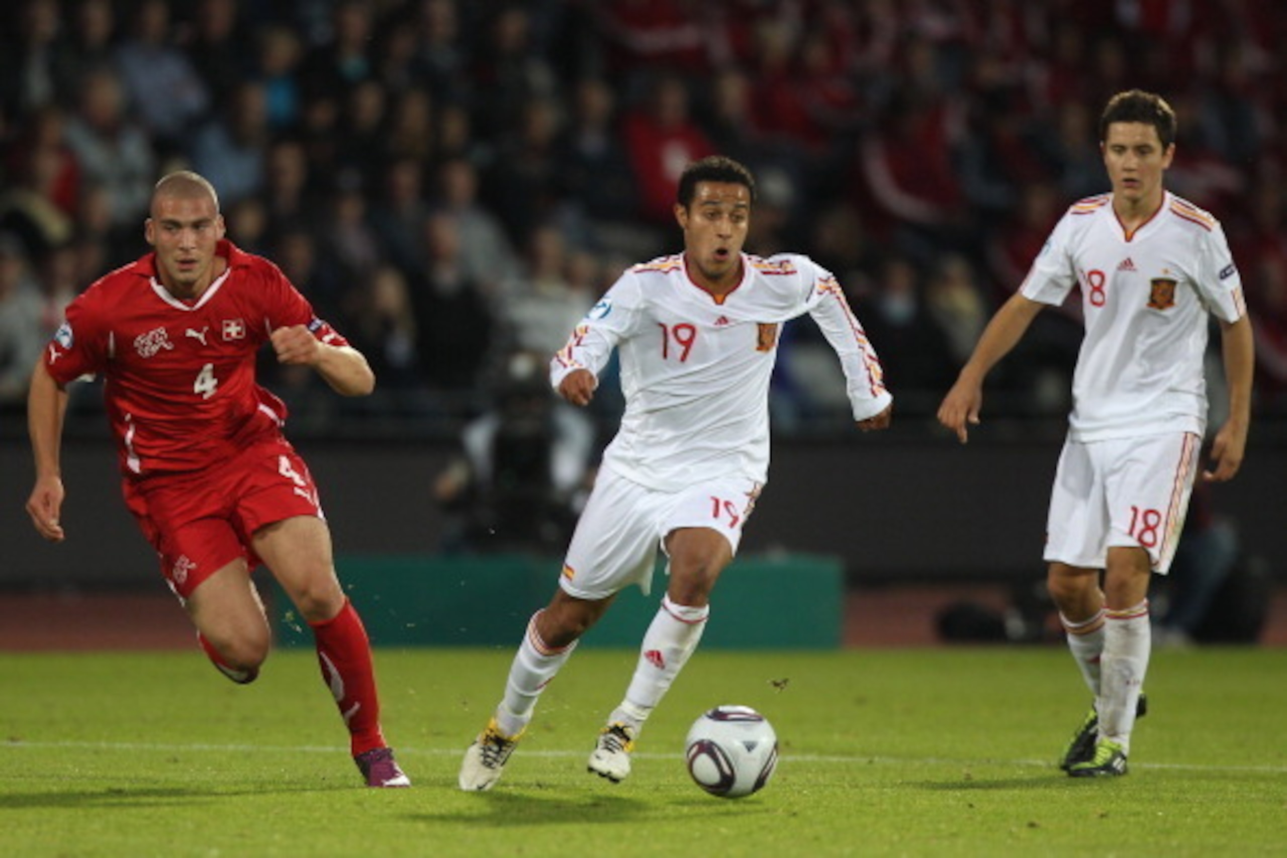 ARHUS, DENMARK - JUNE 25:  Thiago Alcantara (C) of Spain chased by Pajtim Kasami (L) of Switzerland during the UEFA European Under-21 Championship Final match between Spain and Switzerland at the Arhus Stadium on June 25, 2011 in Arhus, Denmark.  (Photo b