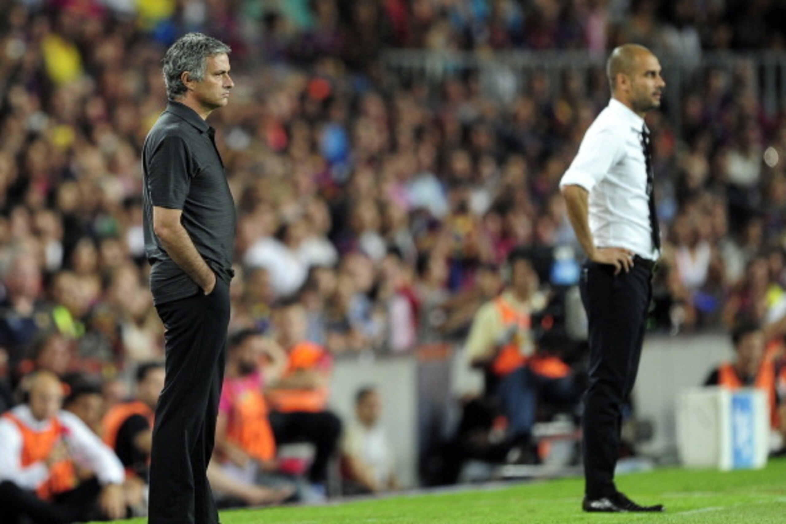 Real Madrid's Portuguese coach Jose Mourinho (L) and Barcelona's coach Josep Guardiola (R) look on during the second leg of the Spanish Supercup football match FC Barcelona vs Real Madrid CF on August 17, 2011 at the Camp Nou stadium in Barcelona.     AFP