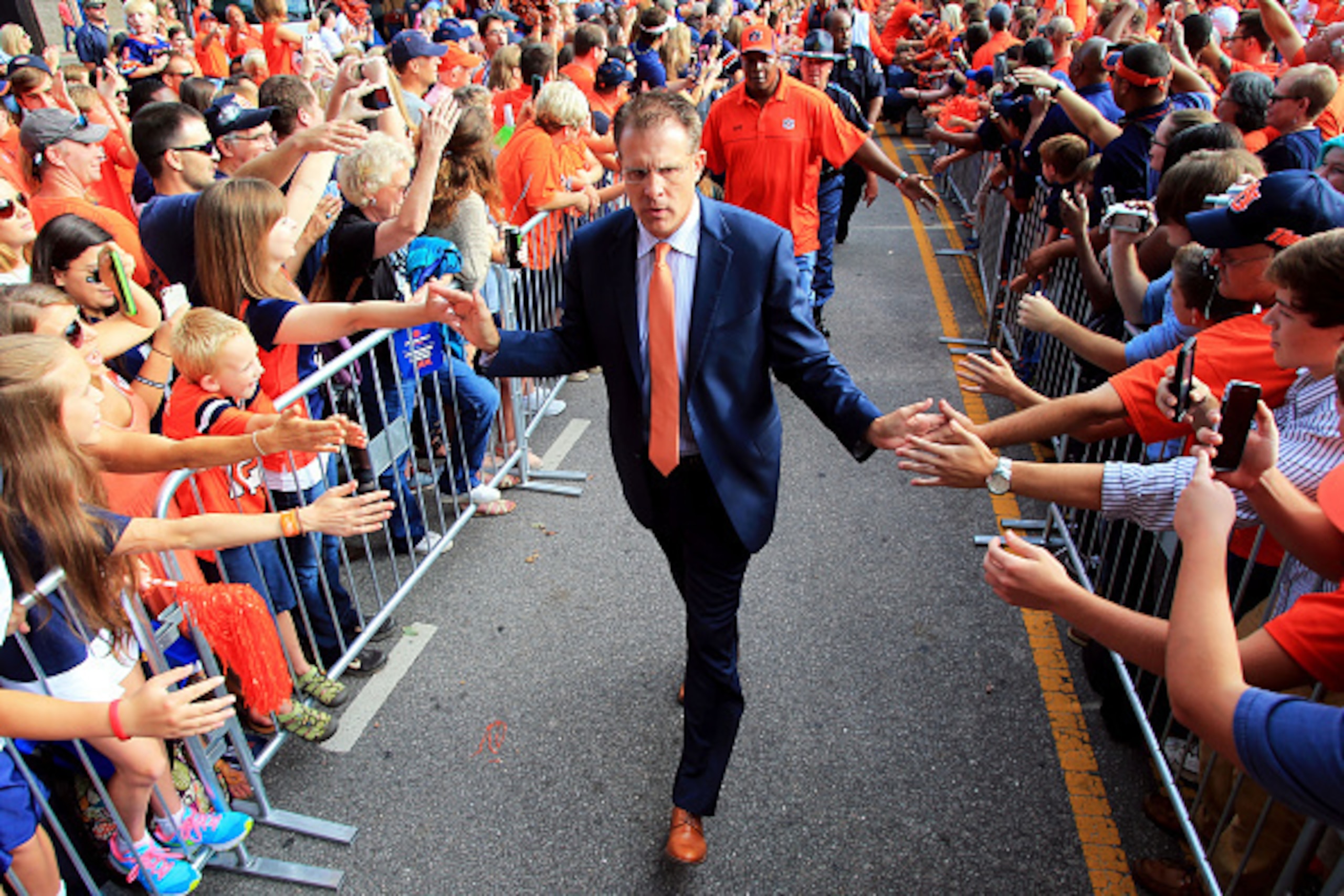 AUBURN, AL - SEPTEMBER 26:  Head coach Gus Malzahn of the Auburn Tigers greets fans during the Tiger Walk prior to the game against the Mississippi State Bulldogs at Jordan Hare Stadium on September 26, 2015 in Auburn, Alabama.  (Photo by Daniel Shirey/Ge
