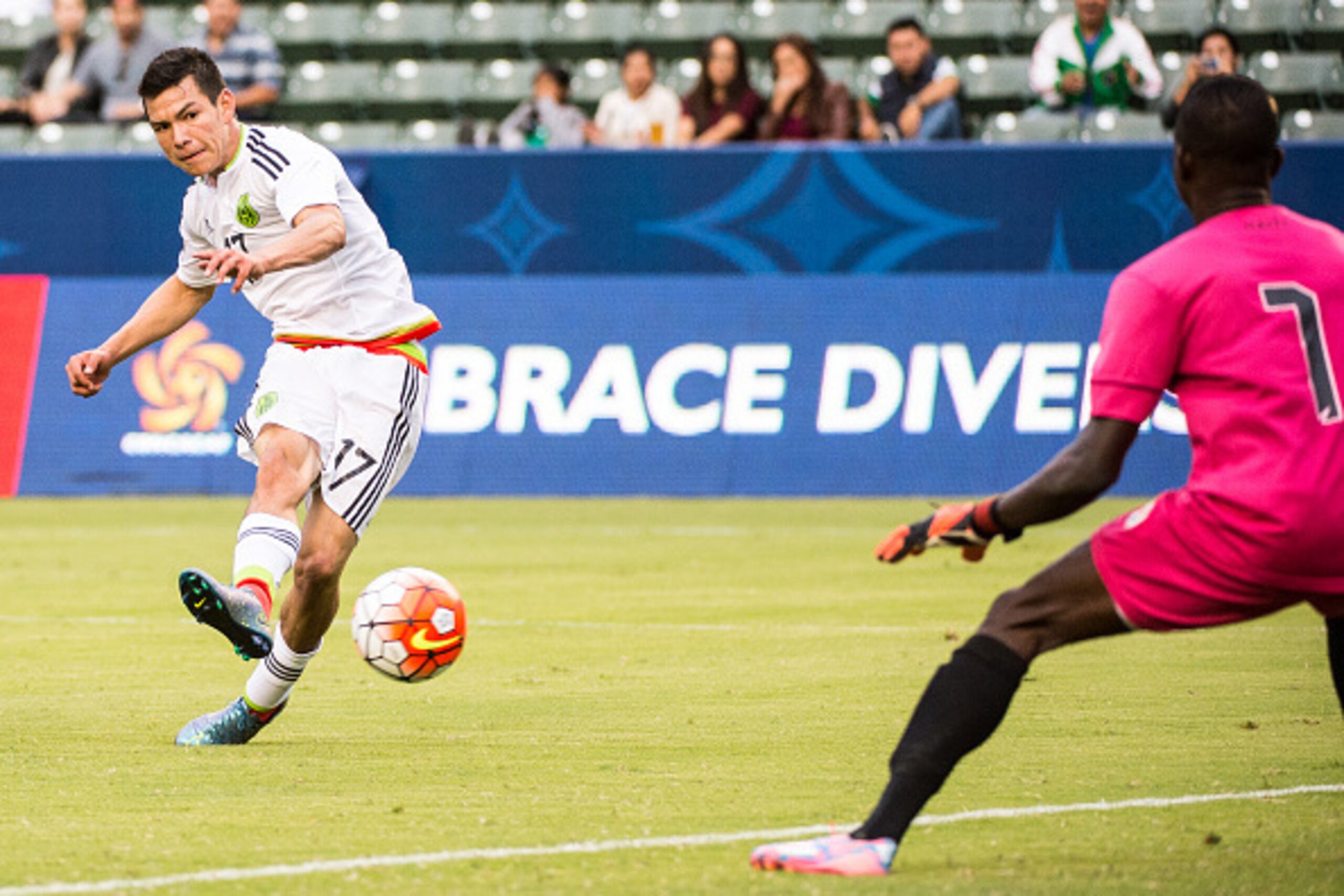 CARSON, CA - OCTOBER 4: Hirving Lozano #17 of Mexico takes a shot on goal as Luis Odelus #1 of Haiti prepares to make a save during Mexico's Olympic Qualifying match against Haiti at the StubHub Center on October 4, 2015 in Carson, California. Mexico won 