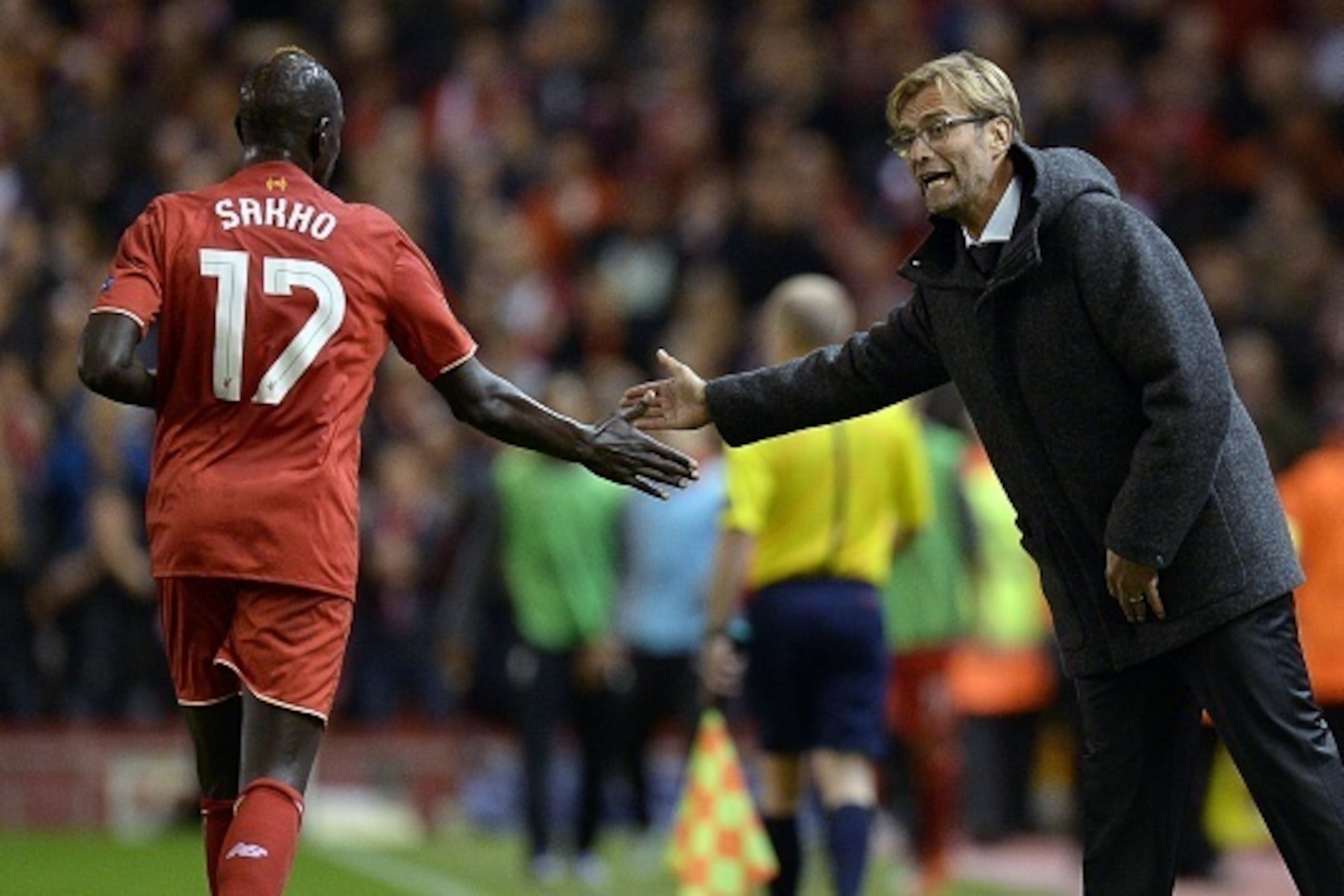 Liverpool's German manager  Jurgen Klopp (R) taps hands with Liverpool's French defender Mamadou Sakho  during a UEFA Europa League group B football match between Liverpool FC and FC Rubin Kazan at Anfield in Liverpool, north west England, on October 22, 